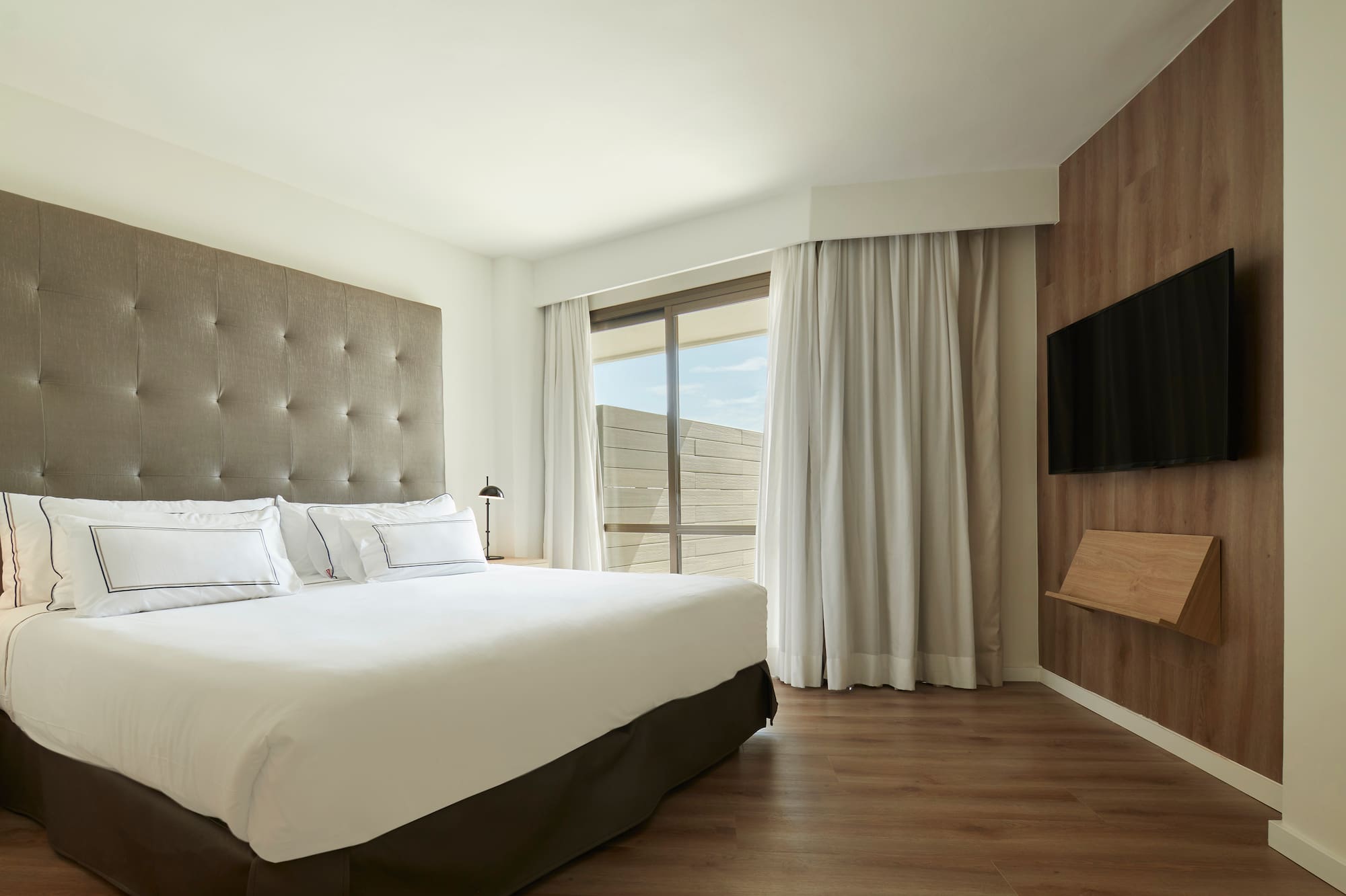 a bedroom with a large bed and a tv