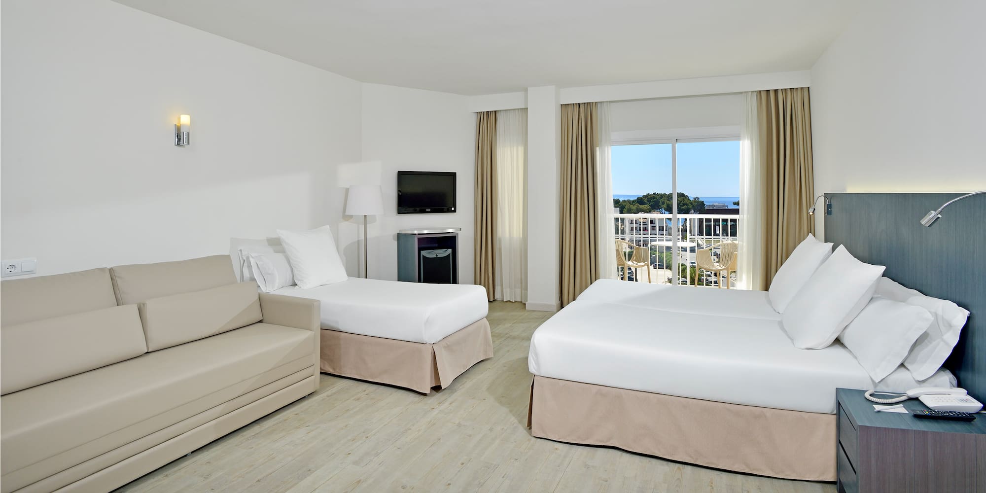 a room with two beds and a television