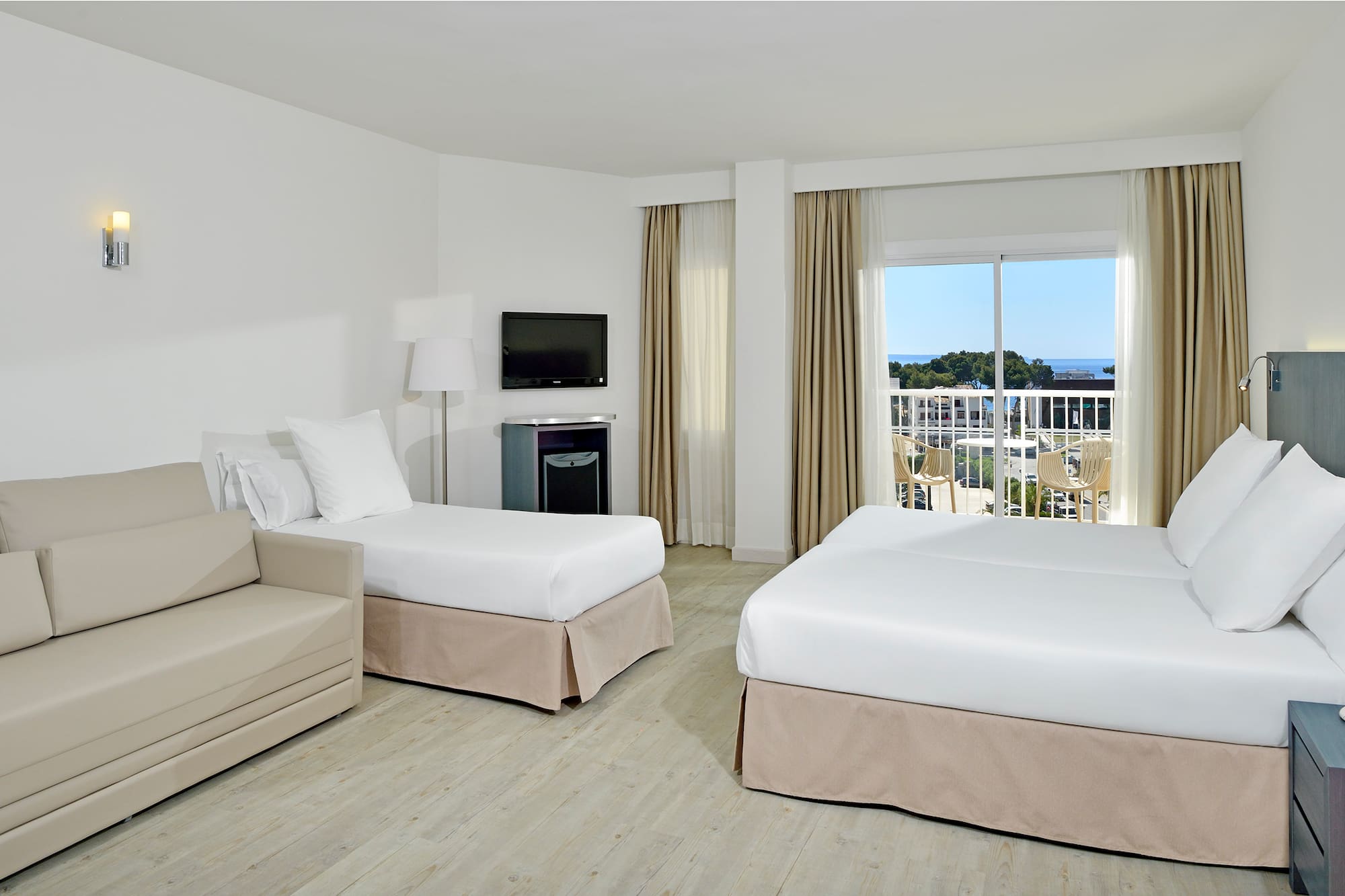 a room with two beds and a television