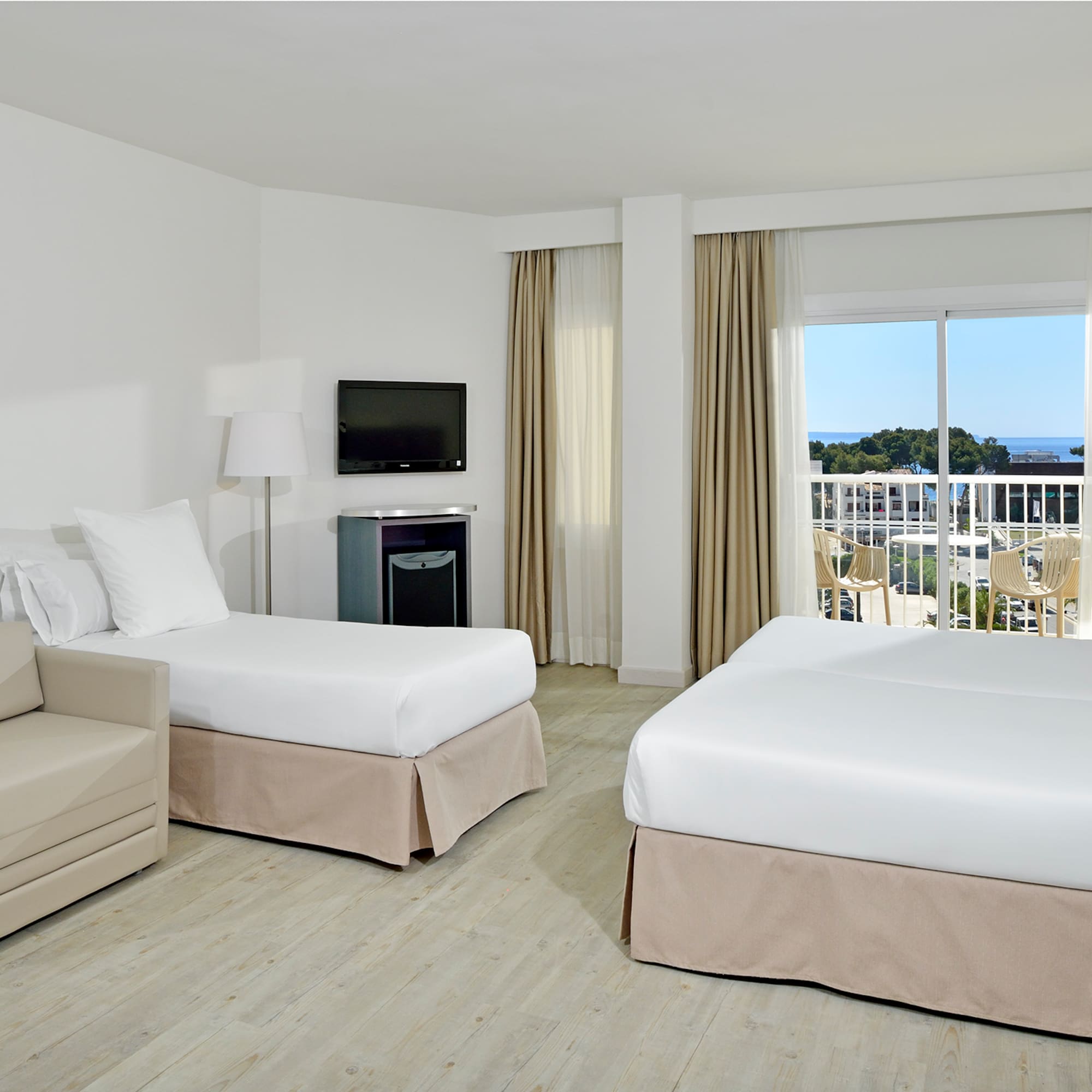 a room with two beds and a television