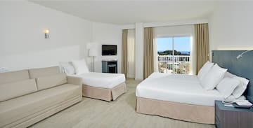 a room with two beds and a television