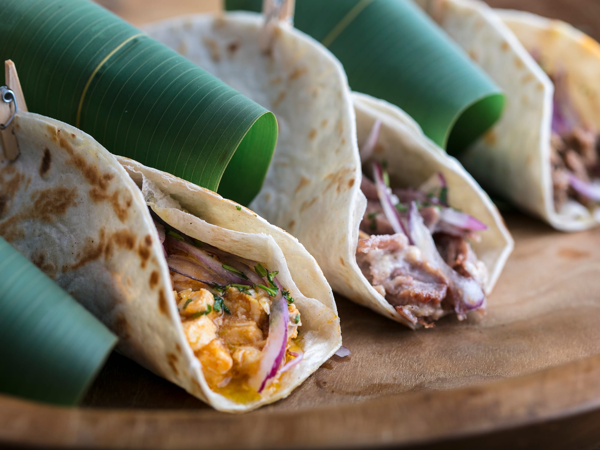 a group of tortillas on a wooden plate