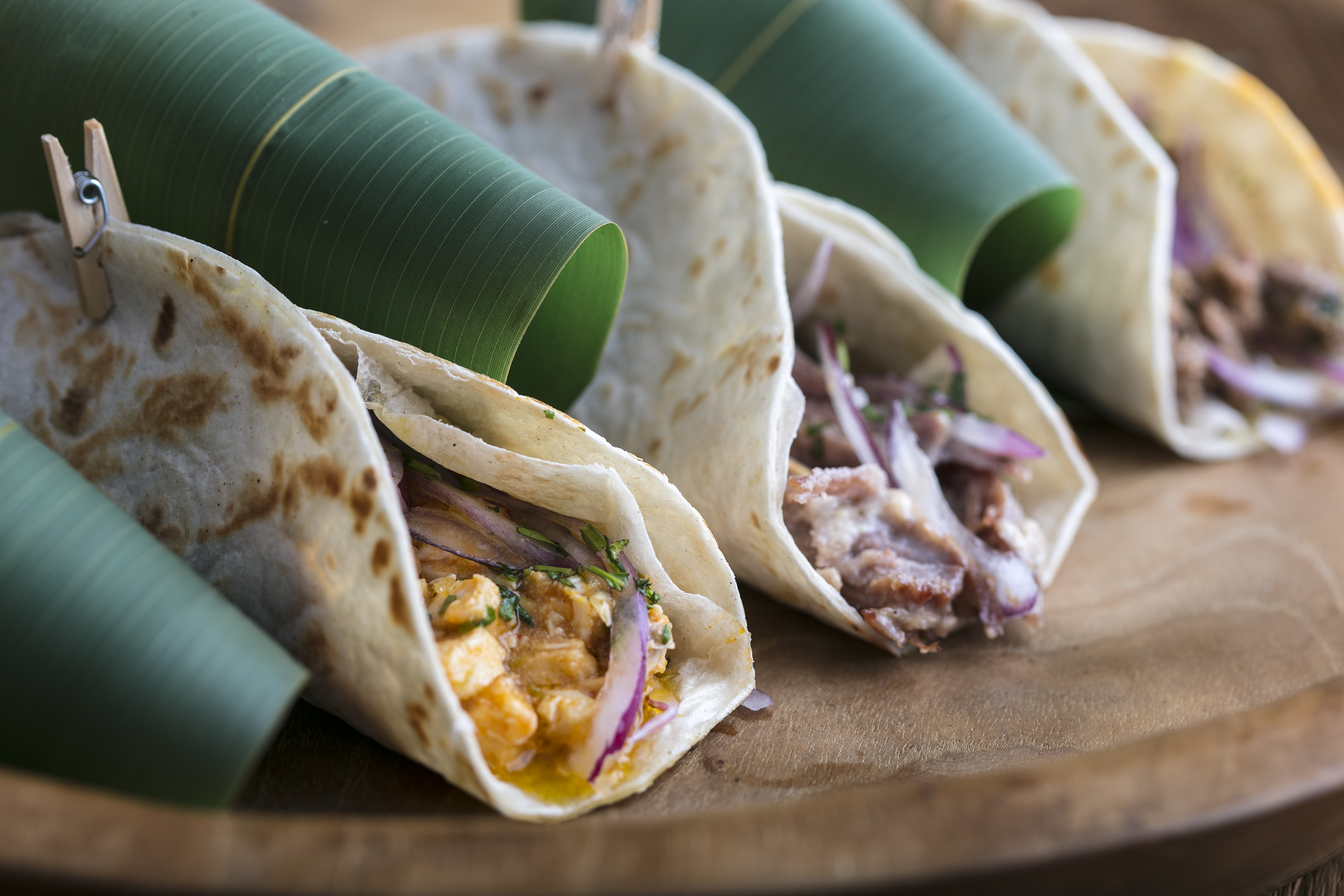 a group of tortillas on a wooden plate