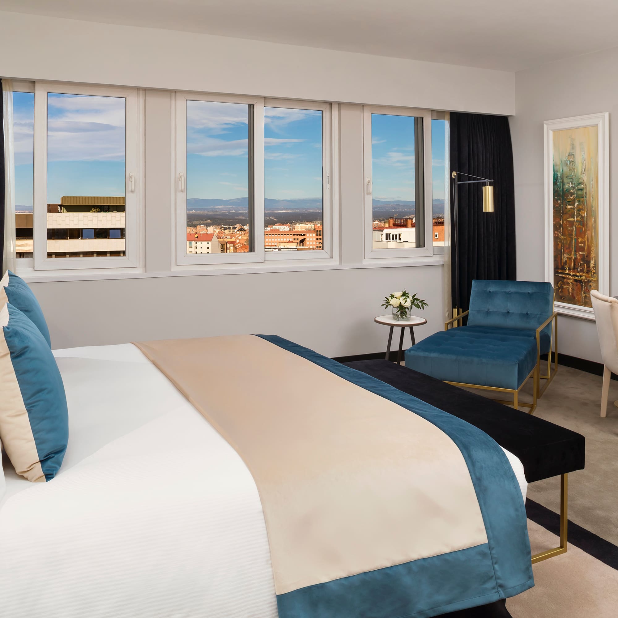 a bedroom with a bed and chairs