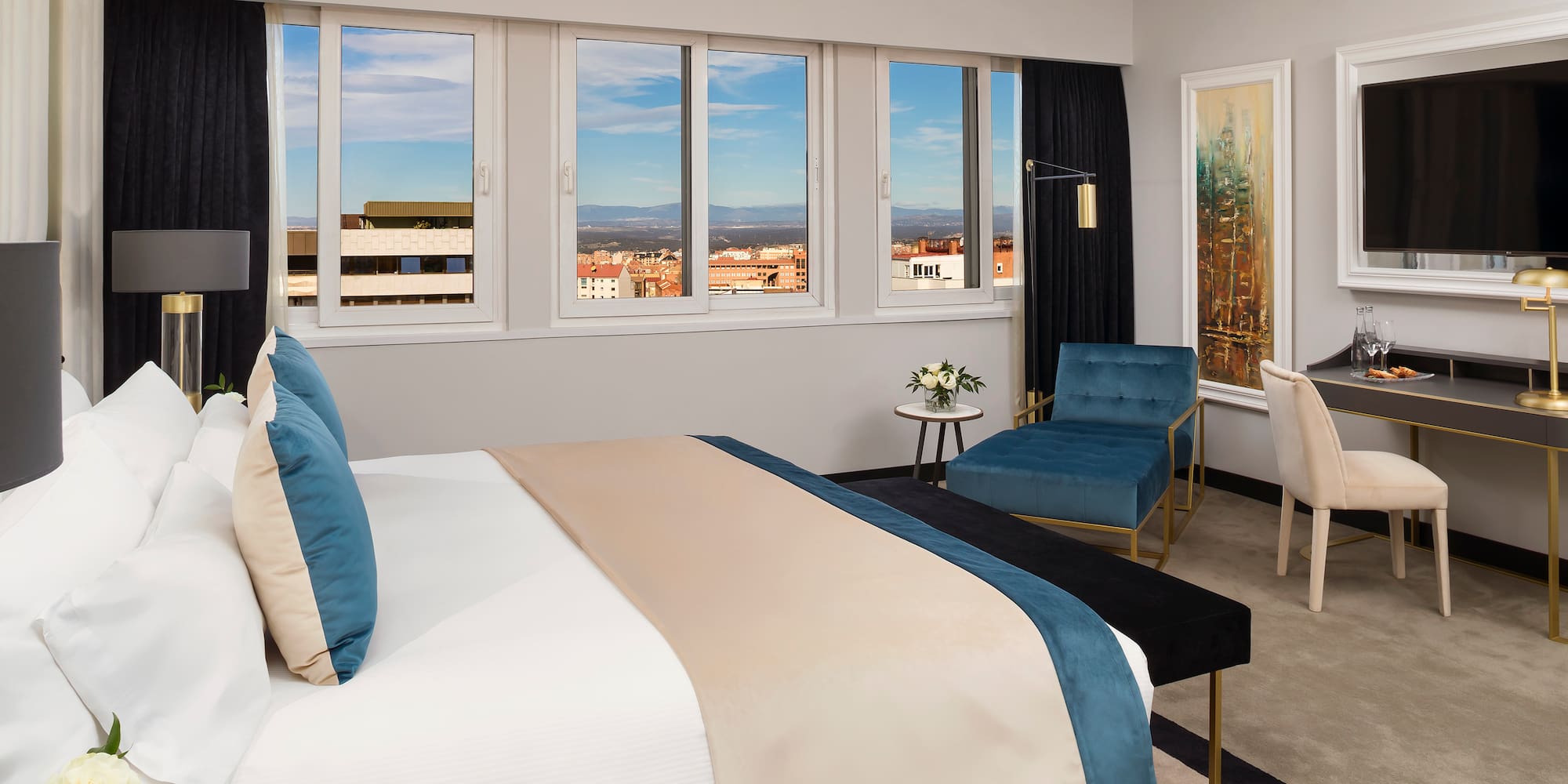 a bedroom with a bed and chairs