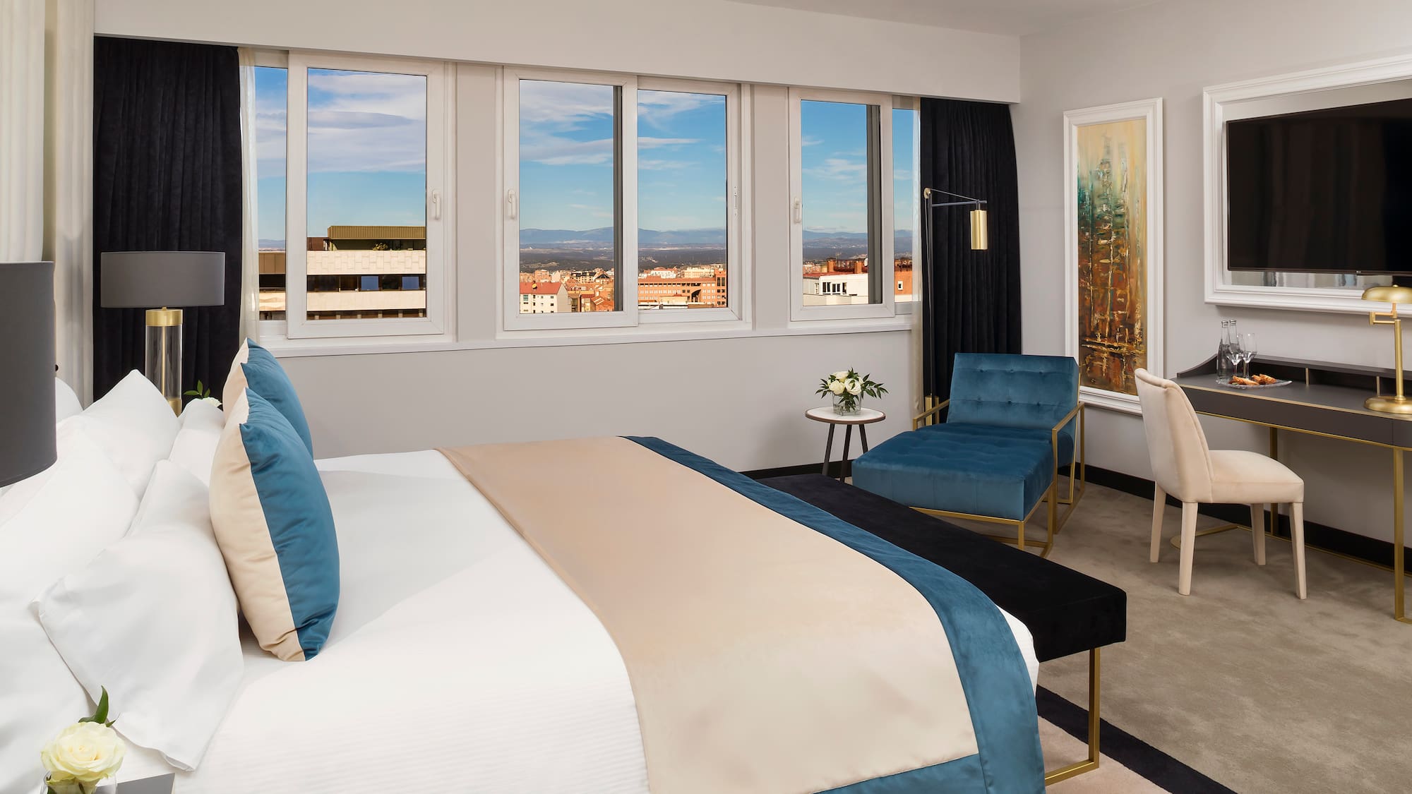 a bedroom with a bed and chairs