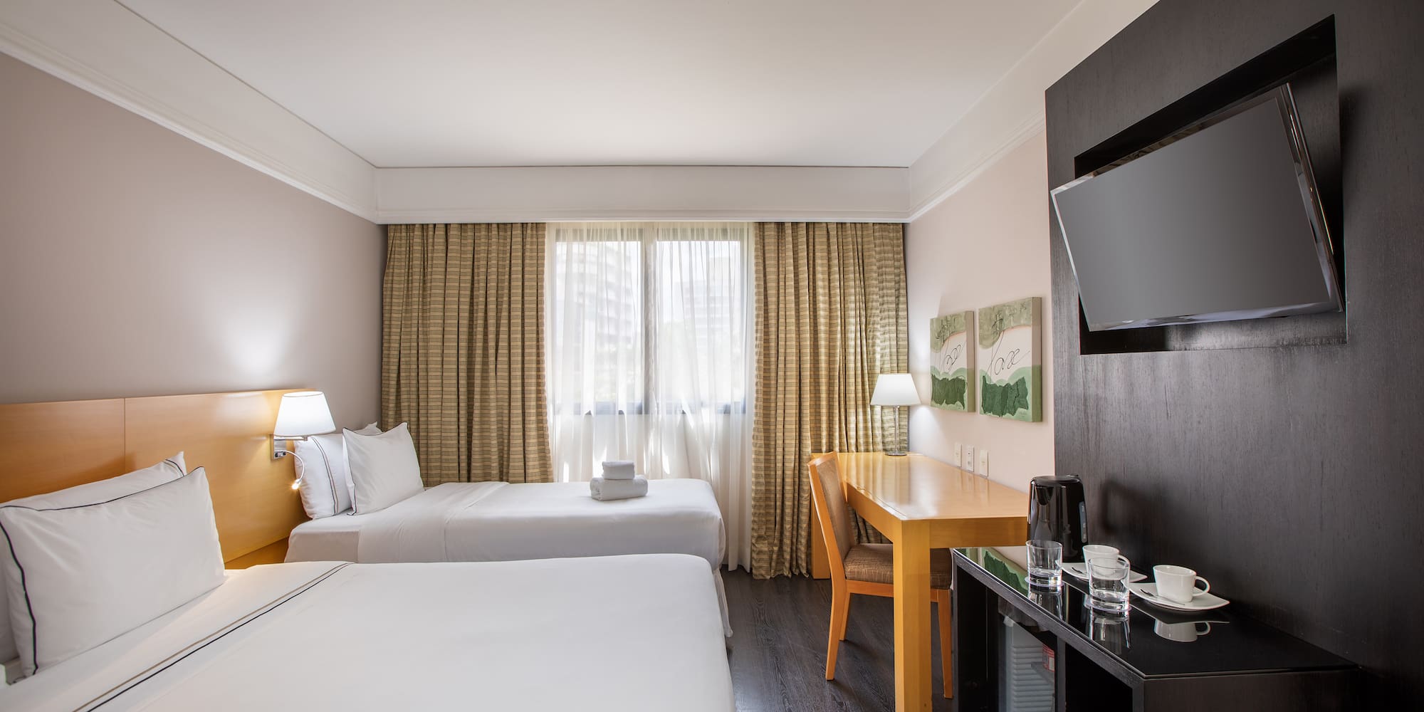 a room with two beds and a tv