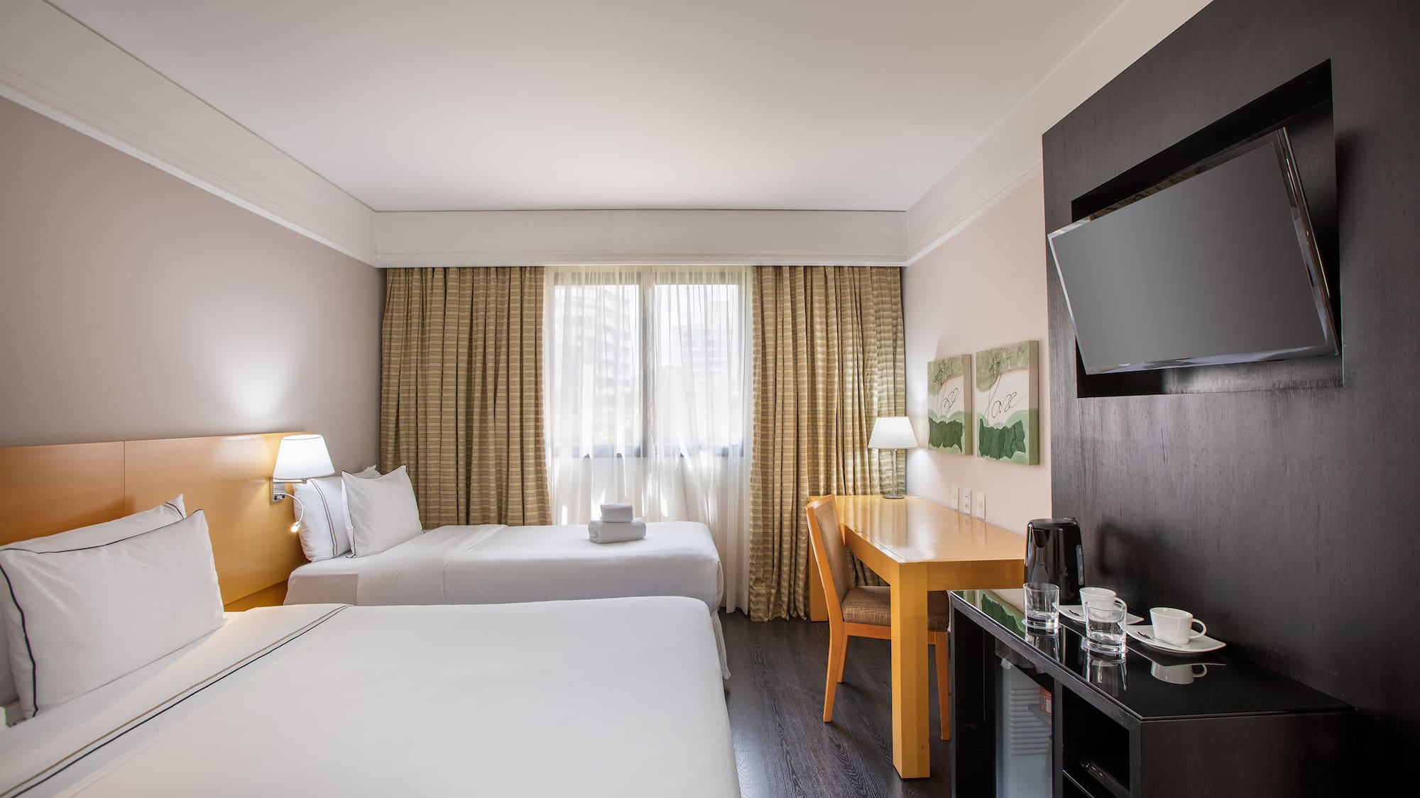 a room with two beds and a tv