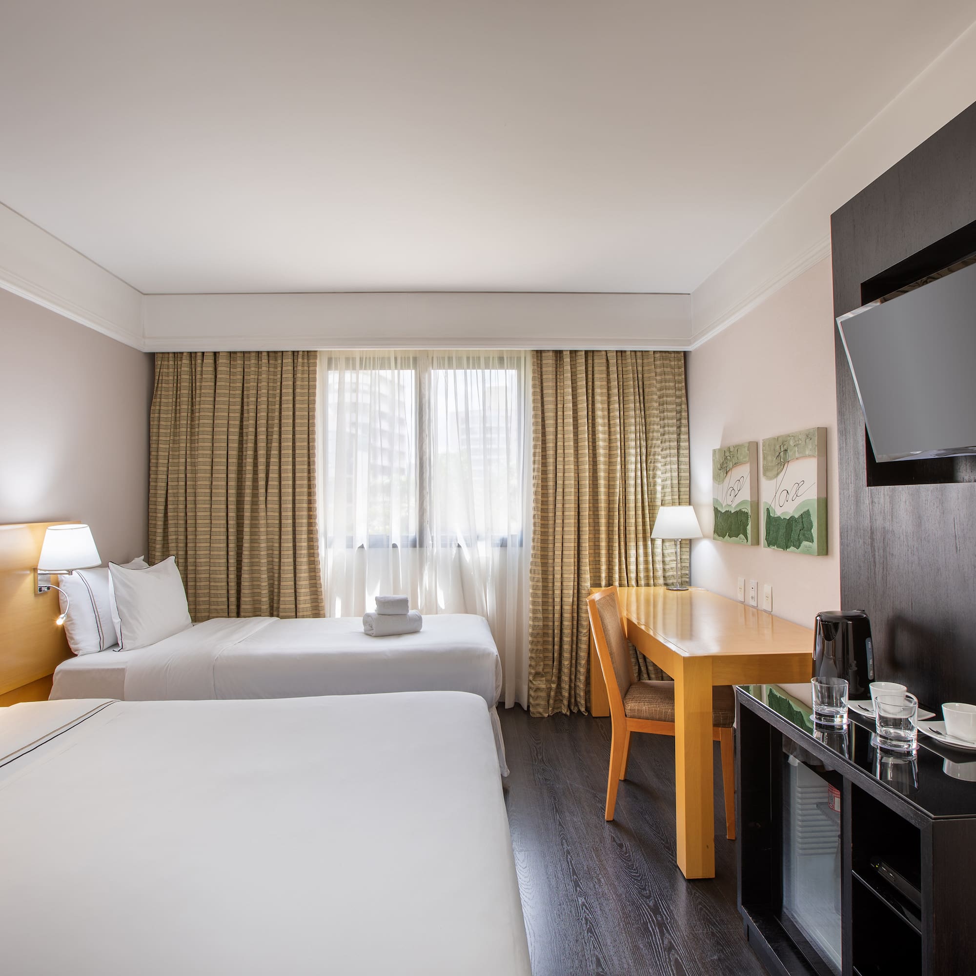 a room with two beds and a tv