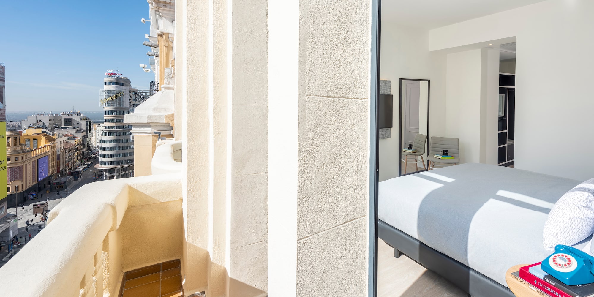 a bedroom with a bed and a balcony