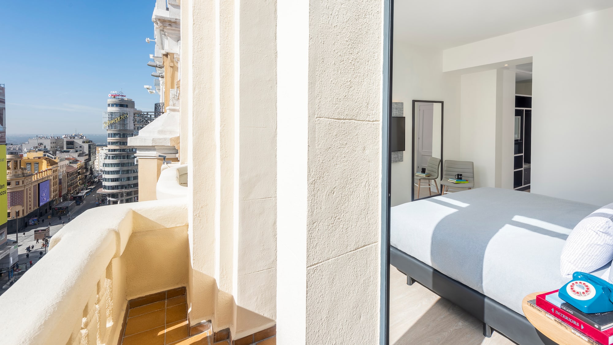 a bedroom with a bed and a balcony