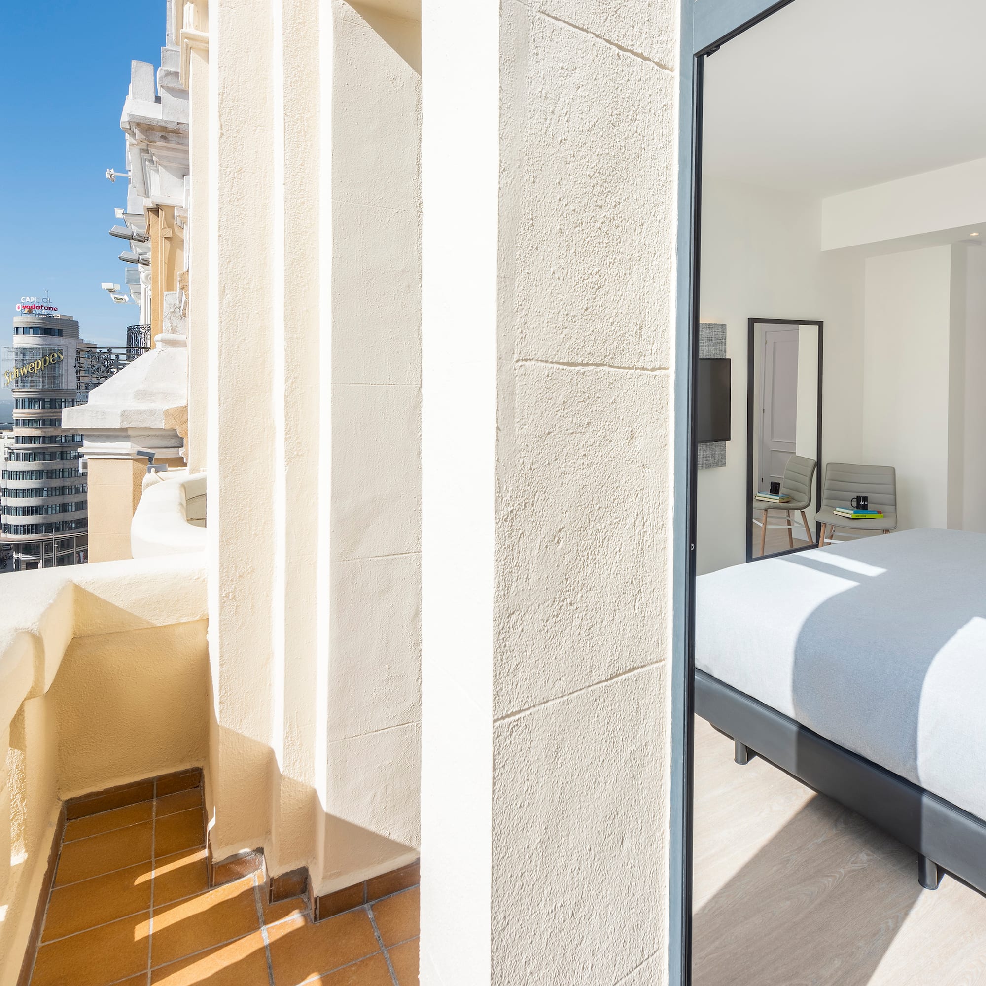 a bedroom with a bed and a balcony