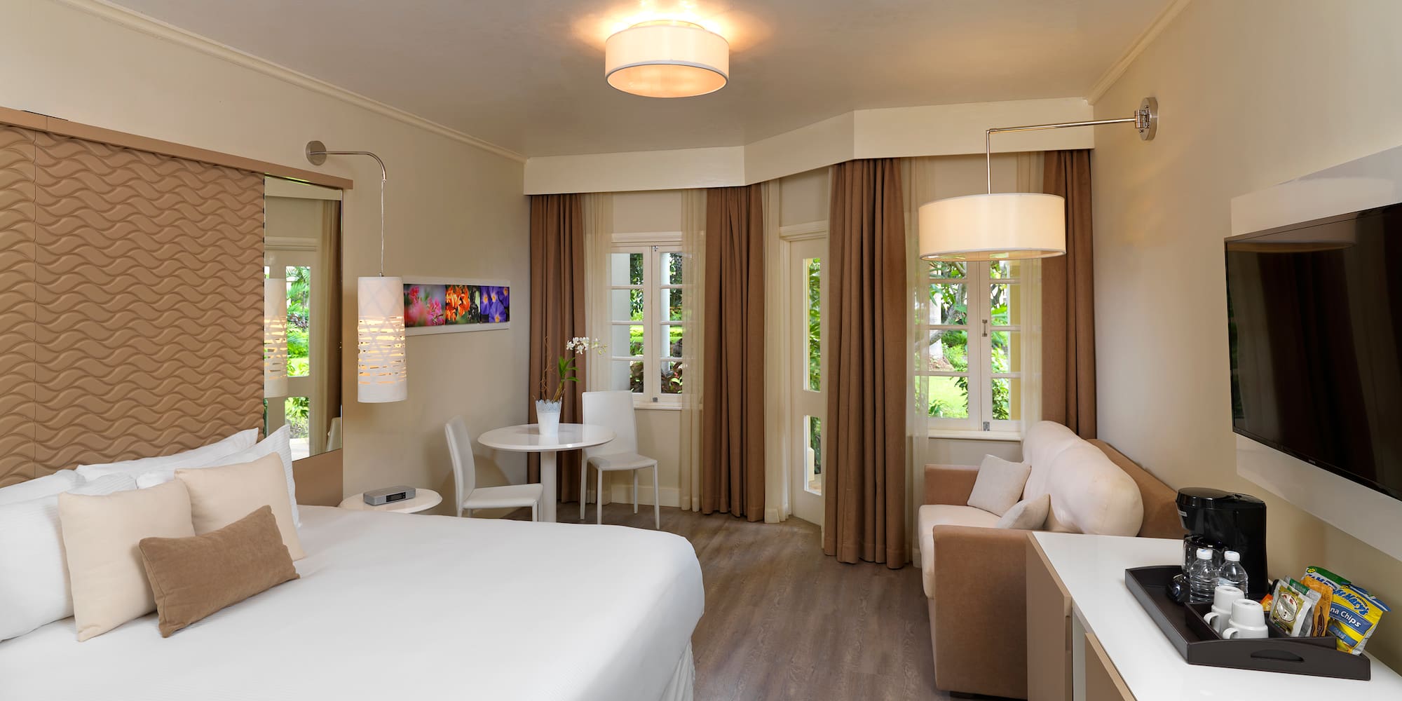 a room with a bed and a table and chairs