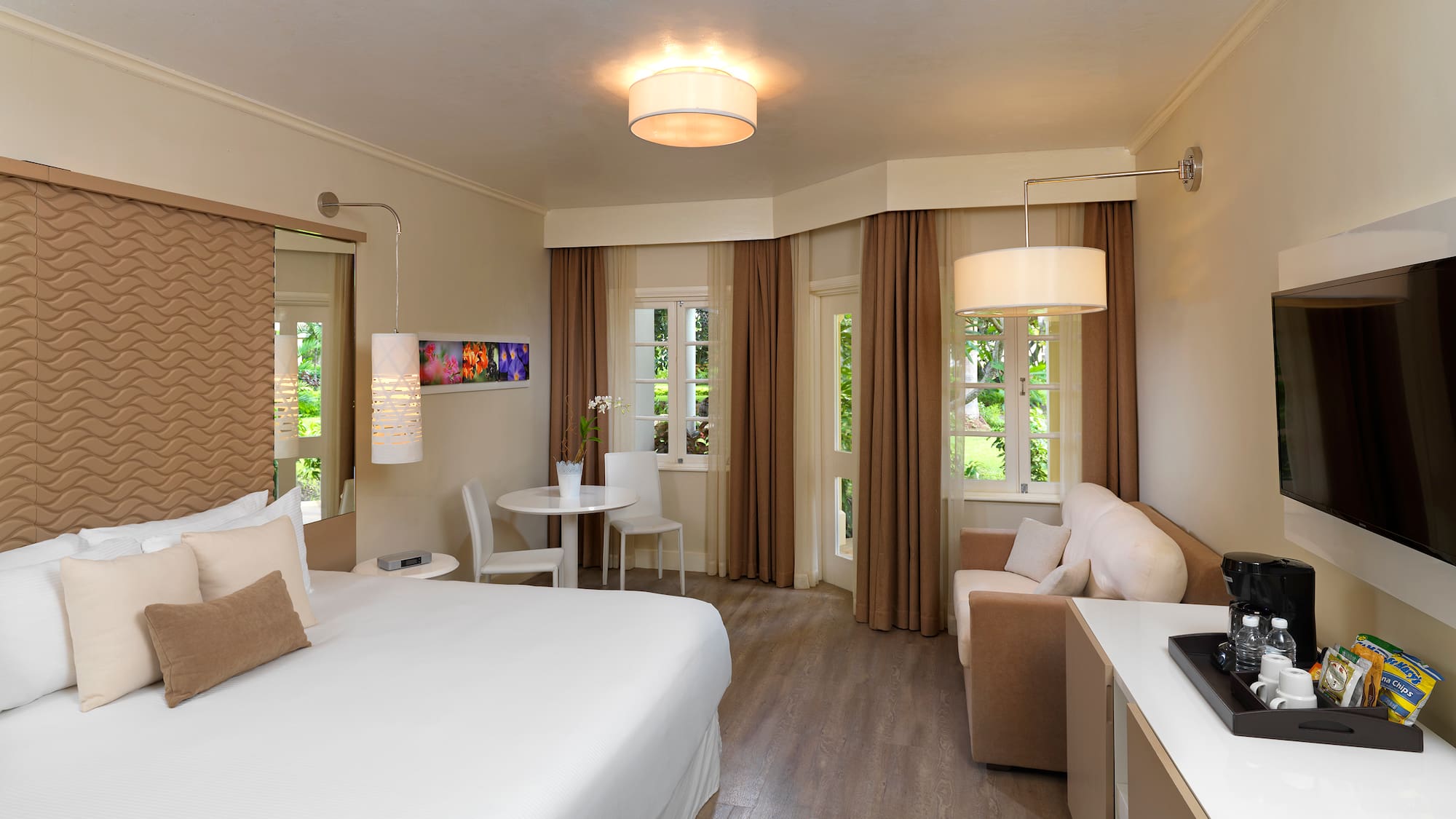 a room with a bed and a table and chairs