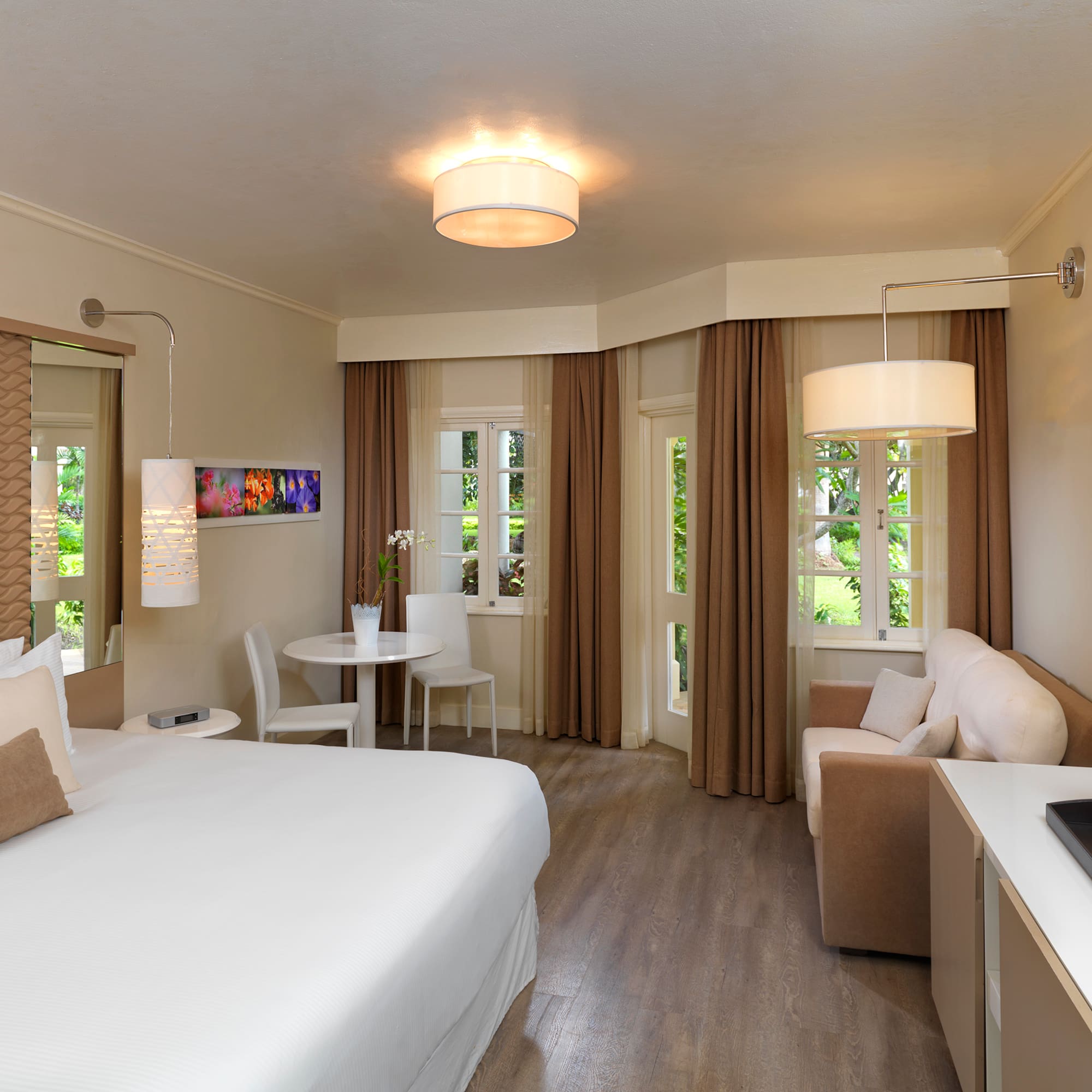 a room with a bed and a table and chairs