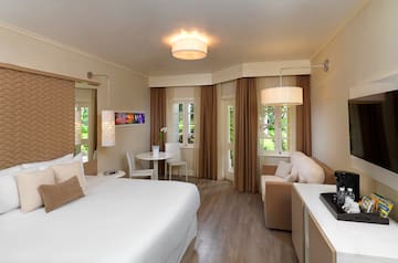 a room with a bed and a table and chairs