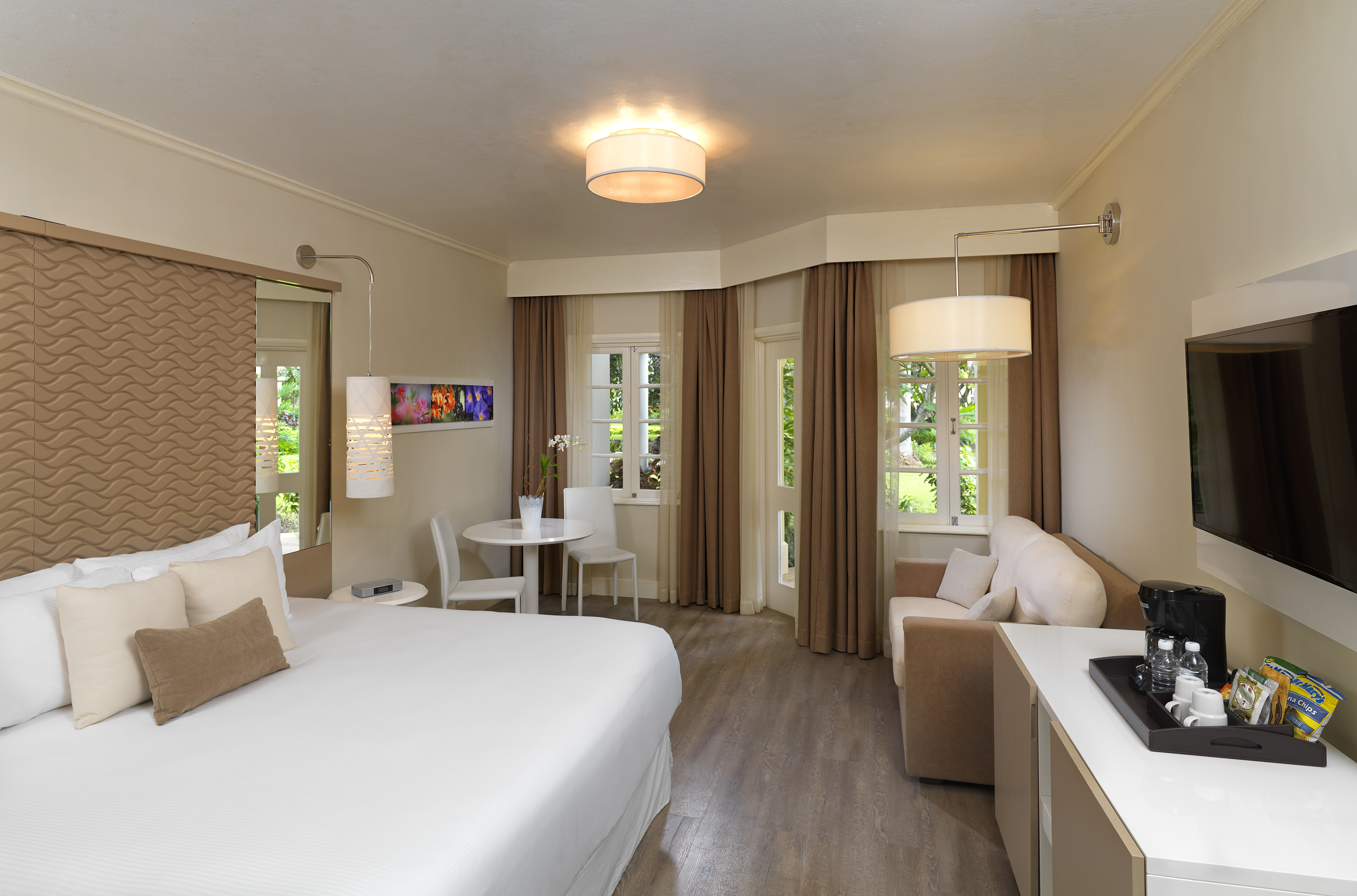 a room with a bed and a table and chairs