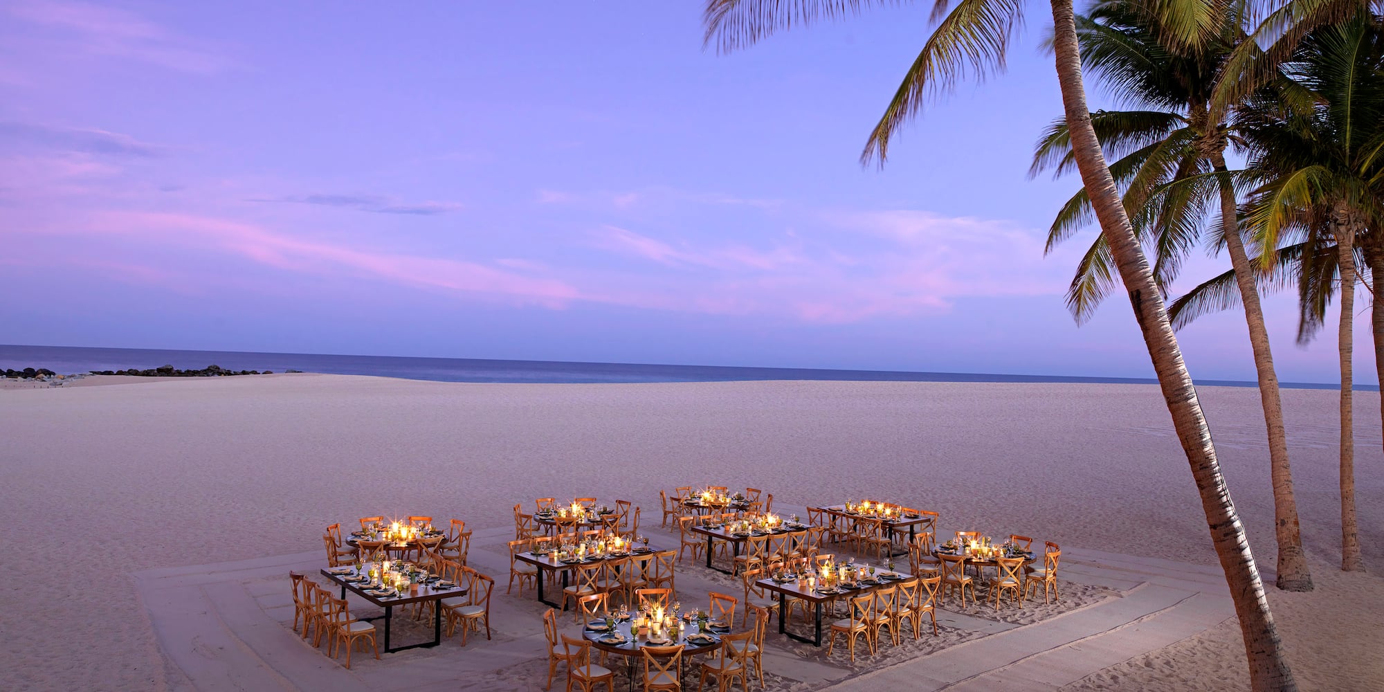 a group of tables and chairs on a beach