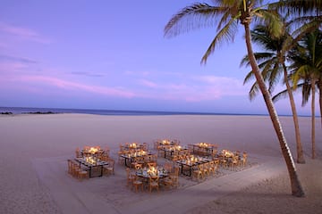 a group of tables and chairs on a beach