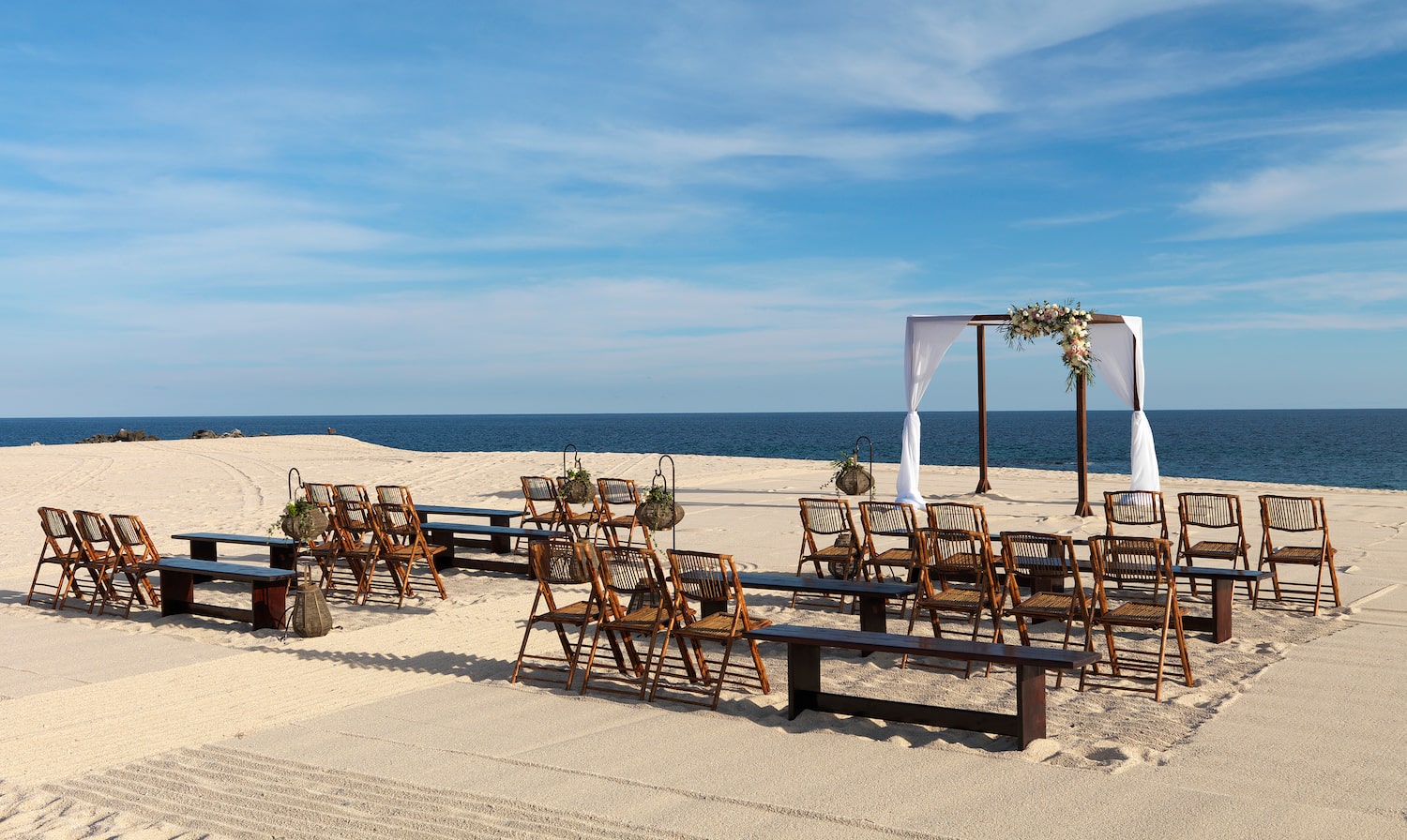 chairs and benches on a beach