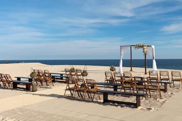 chairs and benches on a beach