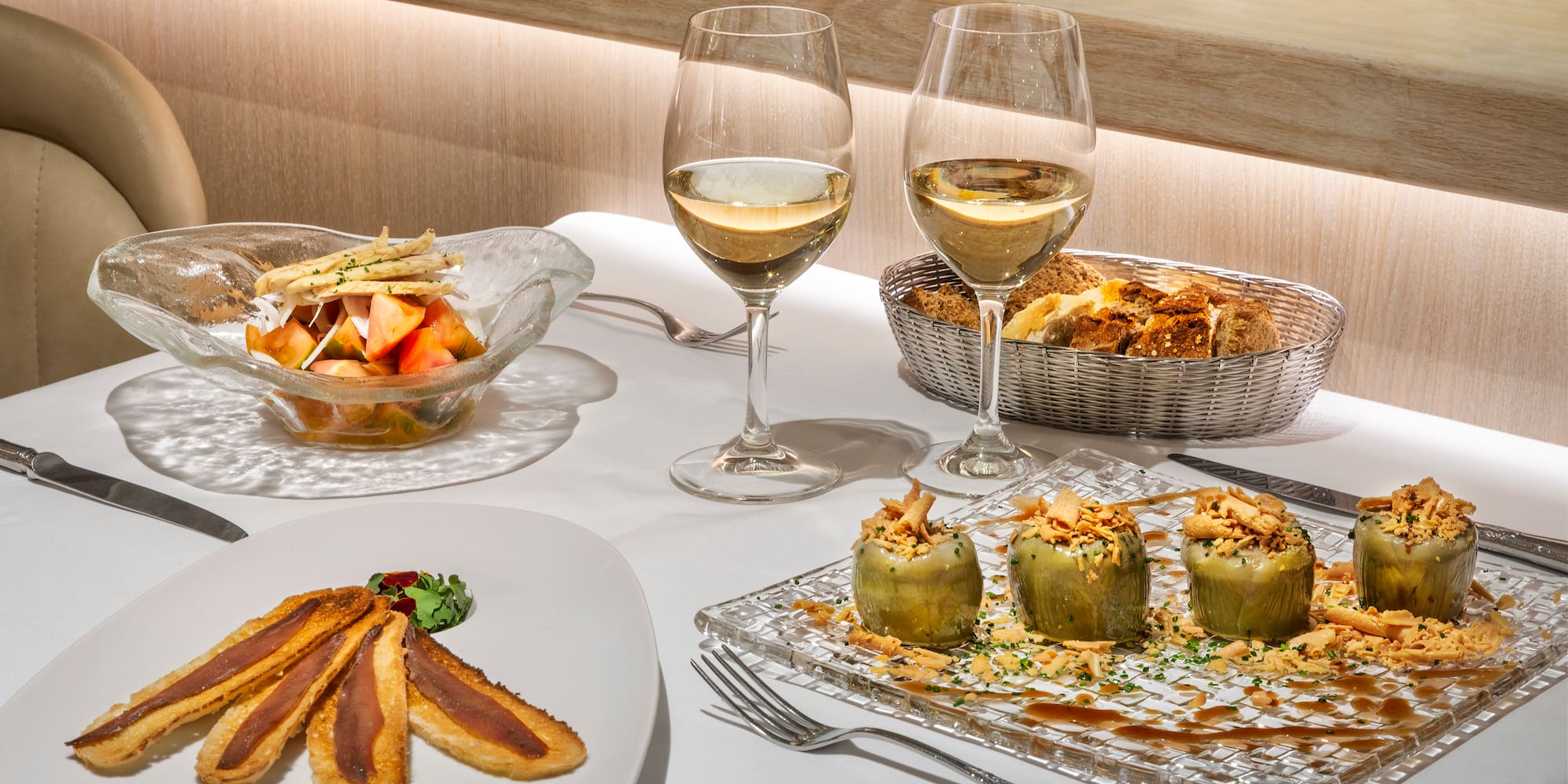 a table with food and wine glasses