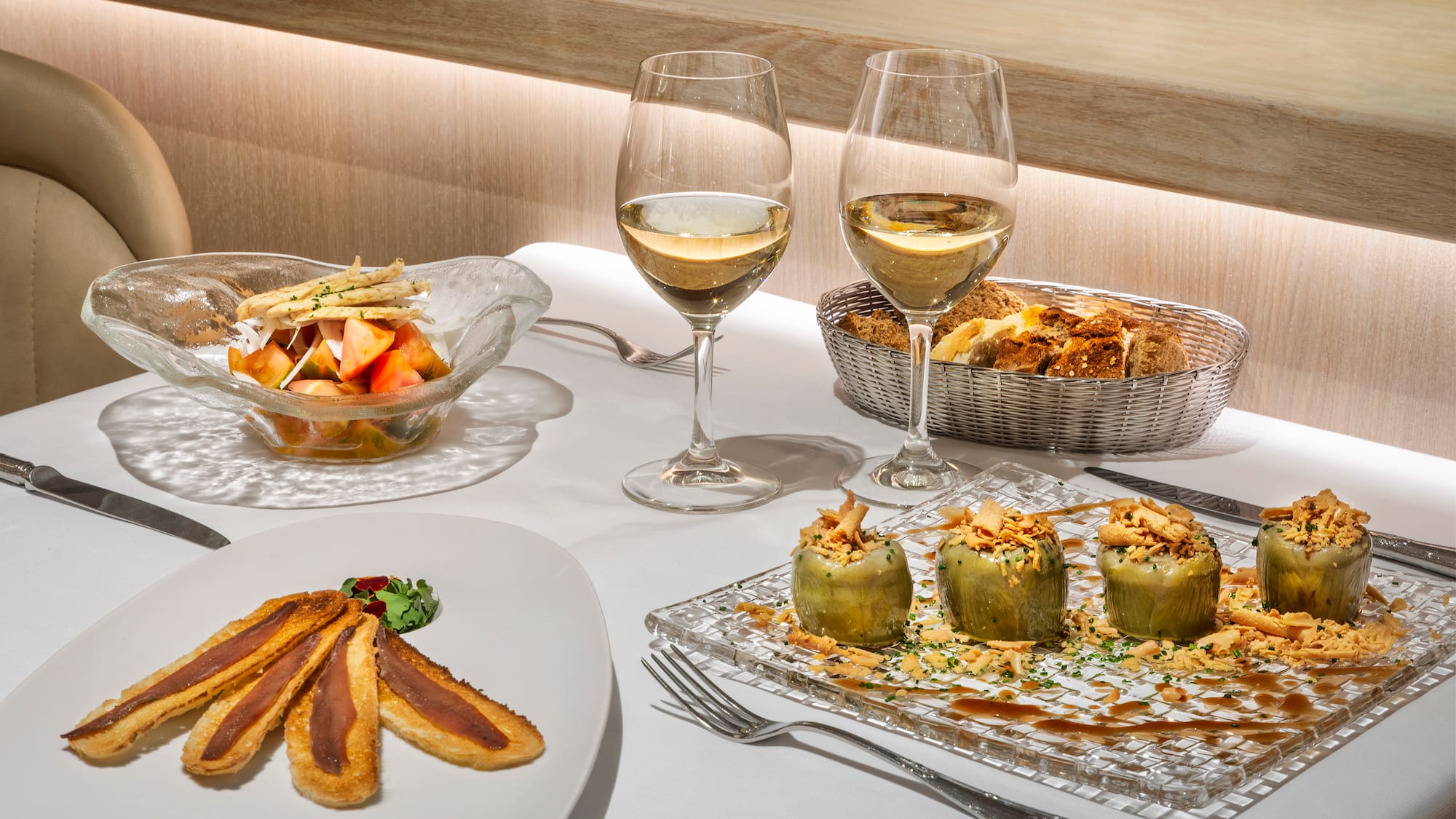 a table with food and wine glasses