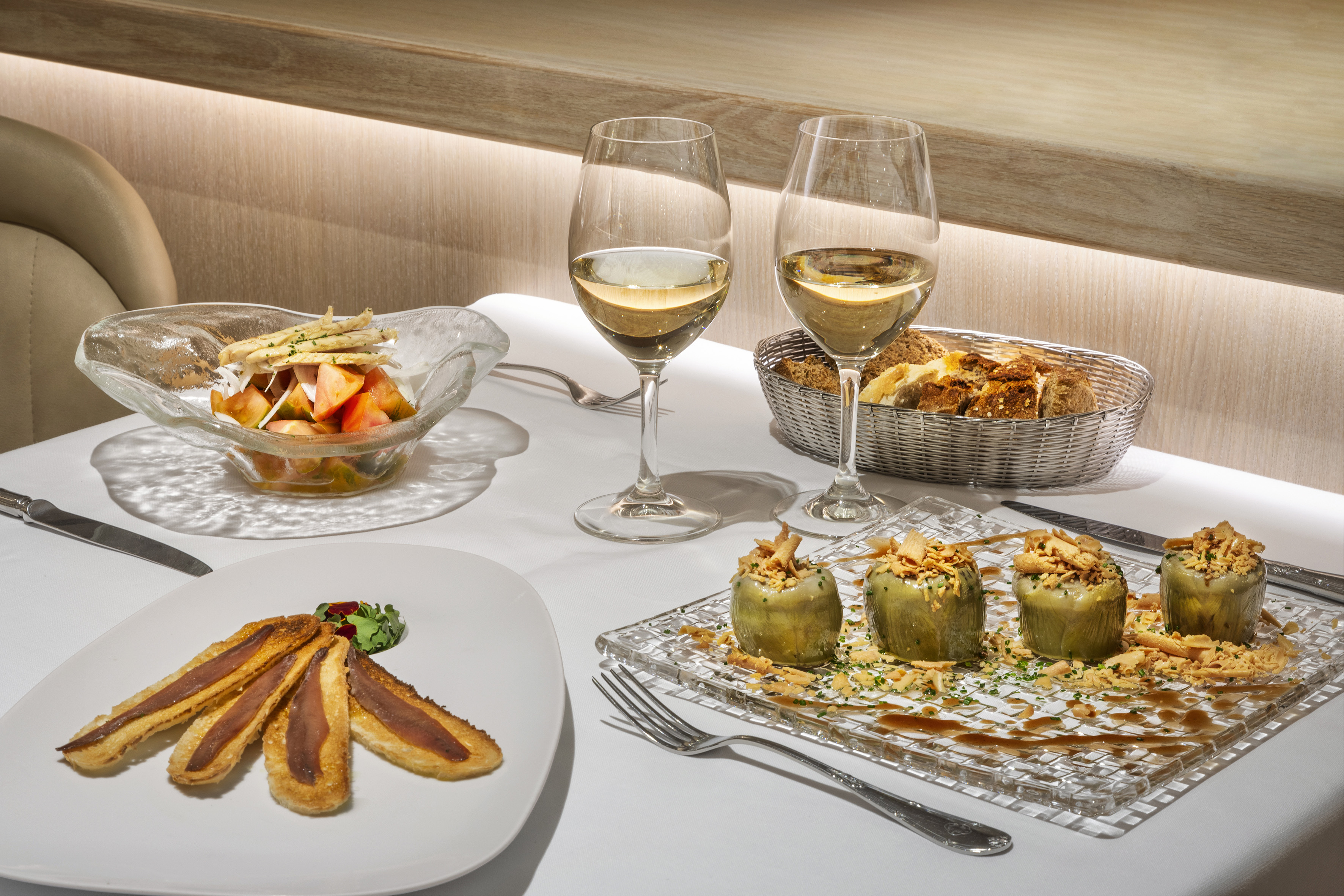a table with food and wine glasses