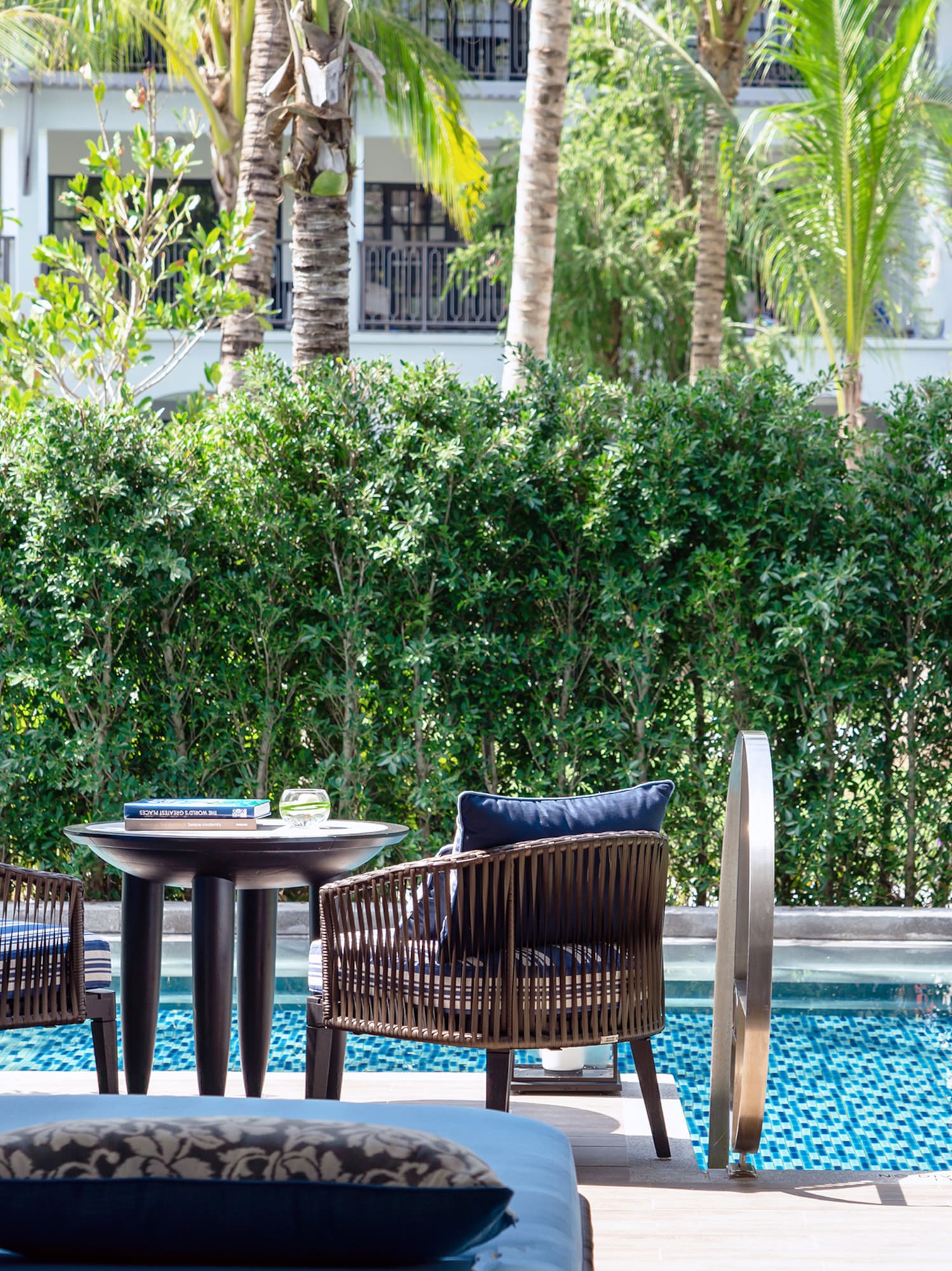 a pool with chairs and tables