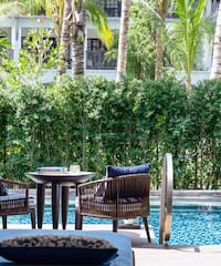 a pool with chairs and tables