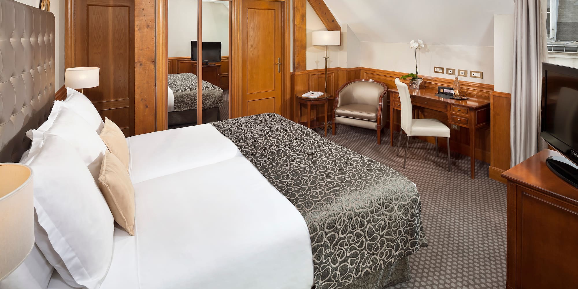 a bedroom with a bed and a desk