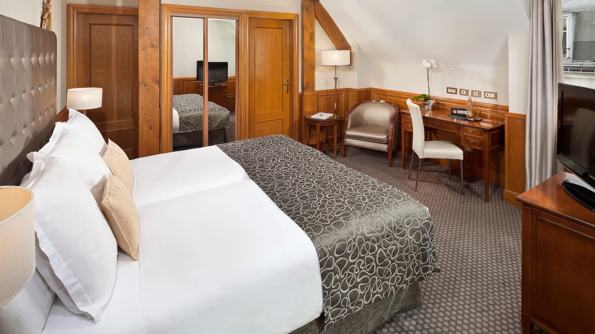 a bedroom with a bed and a desk