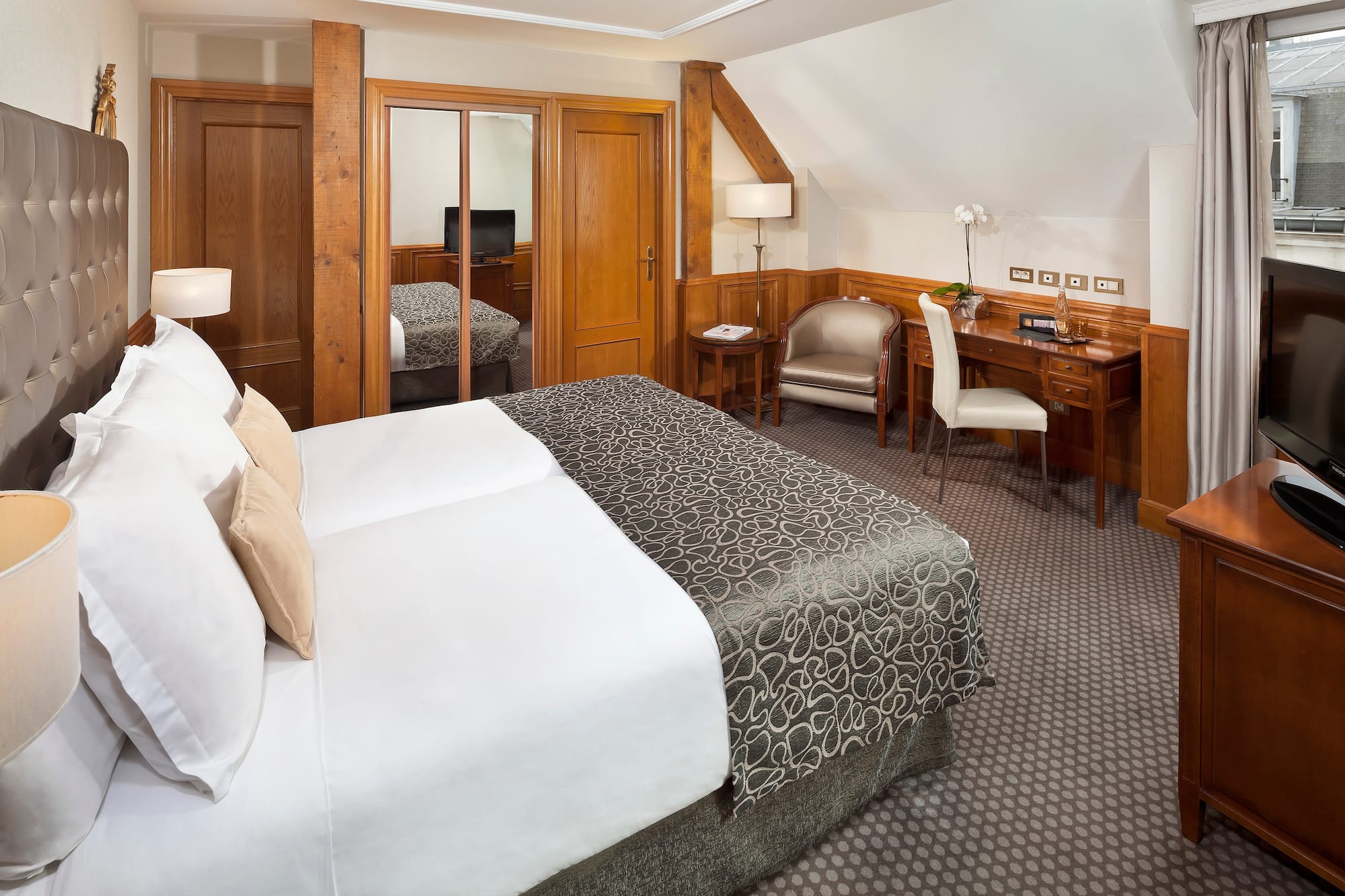 a bedroom with a bed and a desk