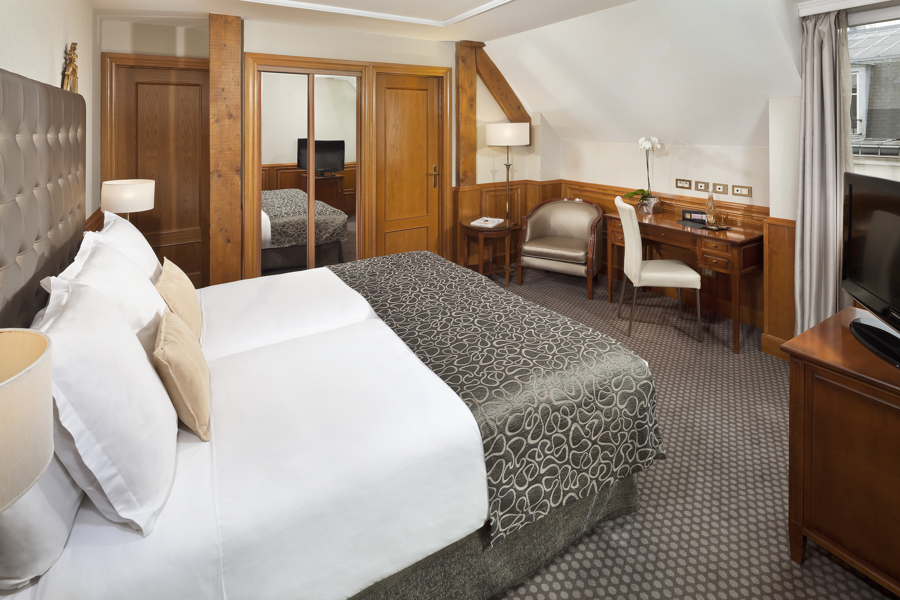 a bedroom with a bed and a desk