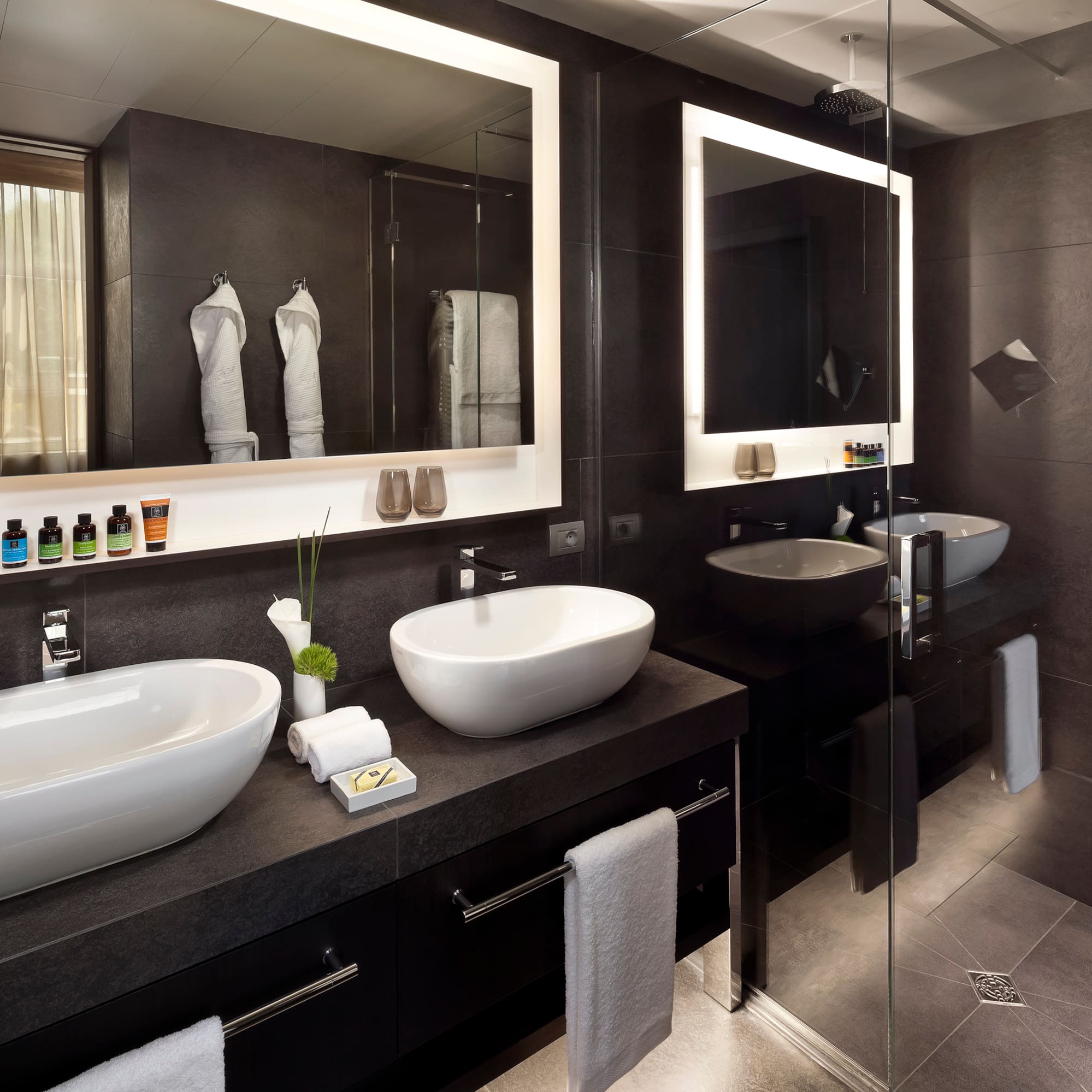 a bathroom with two sinks and a mirror