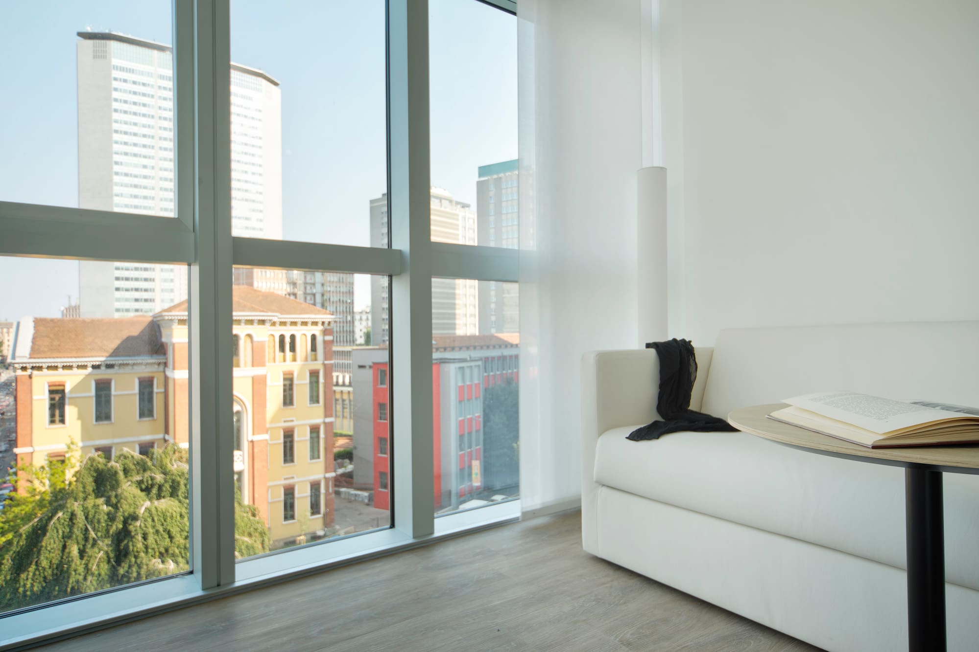 a white couch in a room with large windows