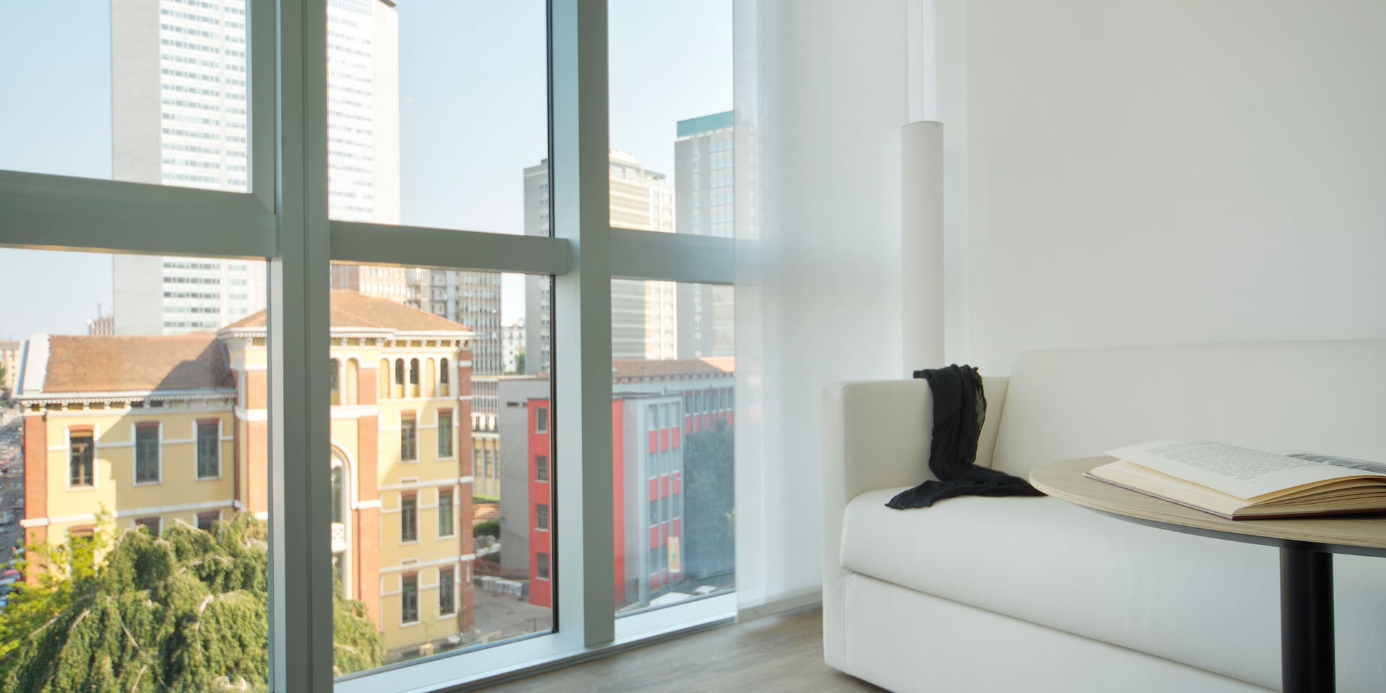 a white couch in a room with large windows