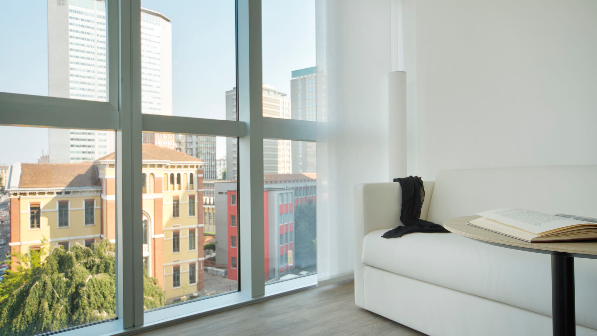 a white couch in a room with large windows