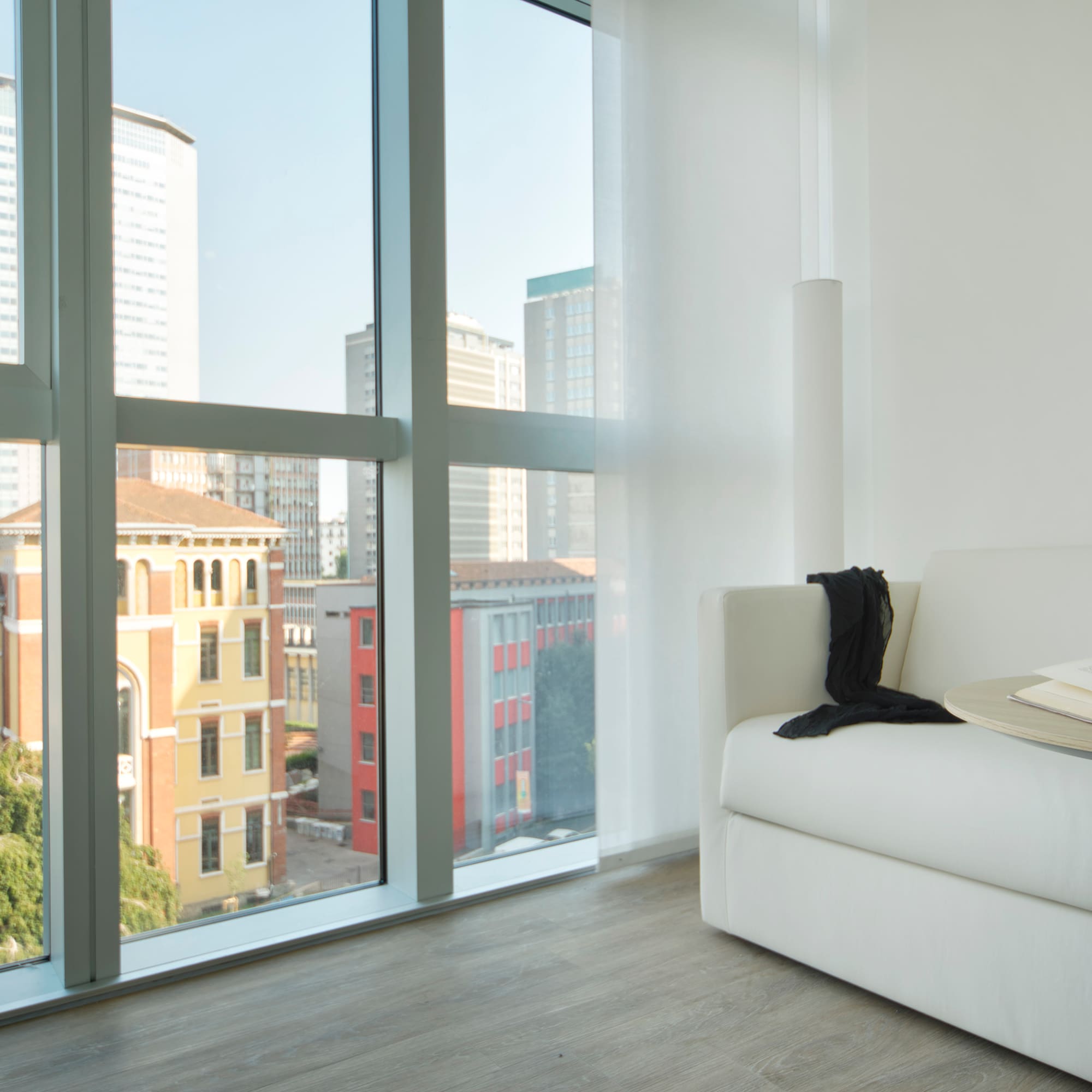 a white couch in a room with large windows