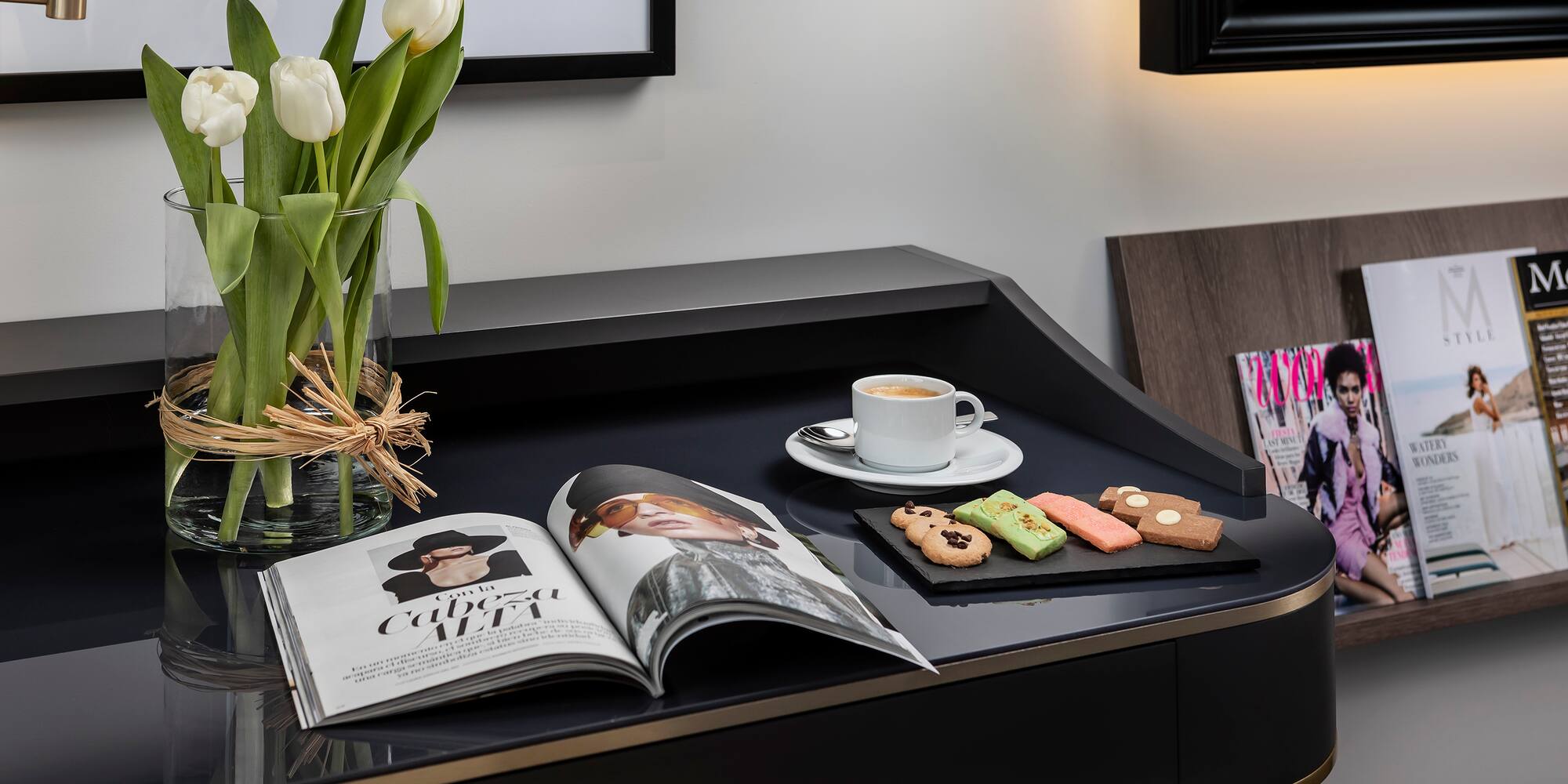 a coffee and cookies on a black table