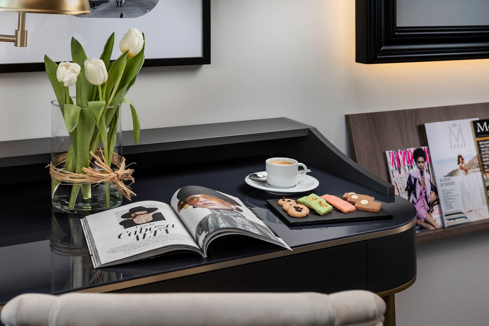 a coffee and cookies on a black table