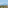 Town with large church, hotels, palm trees, and distant blue mountains.