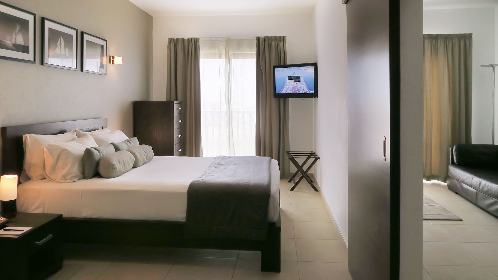 a bedroom with a television and a bed