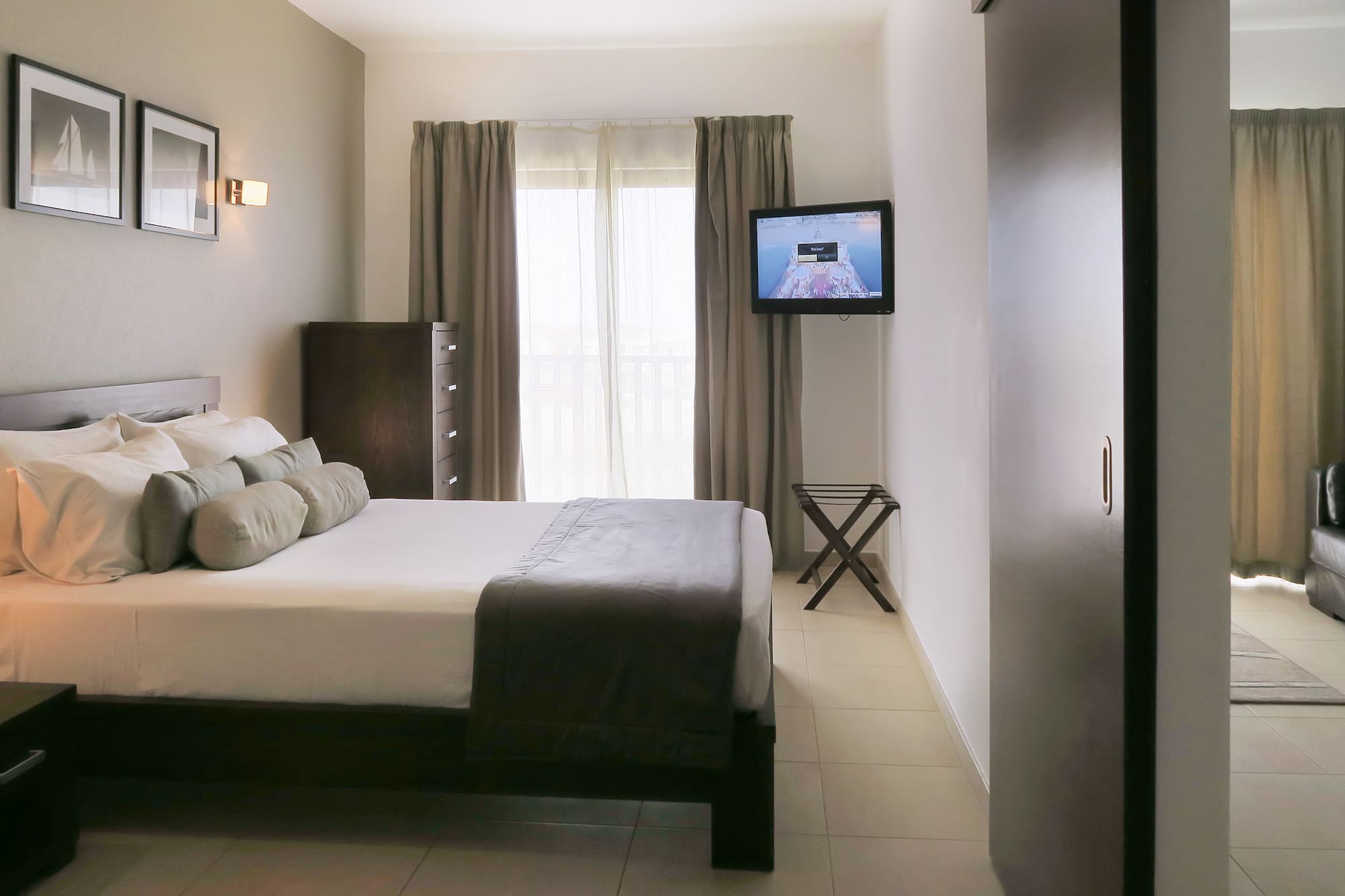 a bedroom with a television and a bed