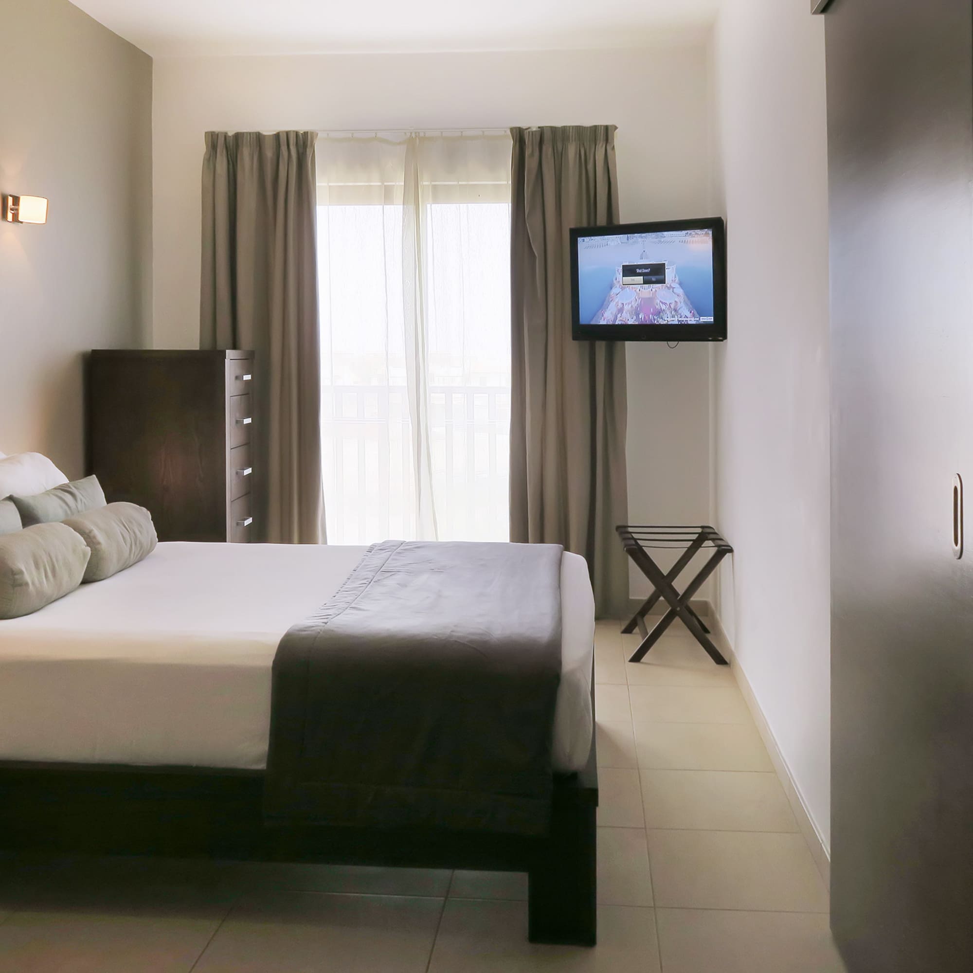 a bedroom with a television and a bed