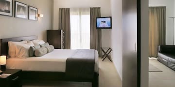 a bedroom with a television and a bed