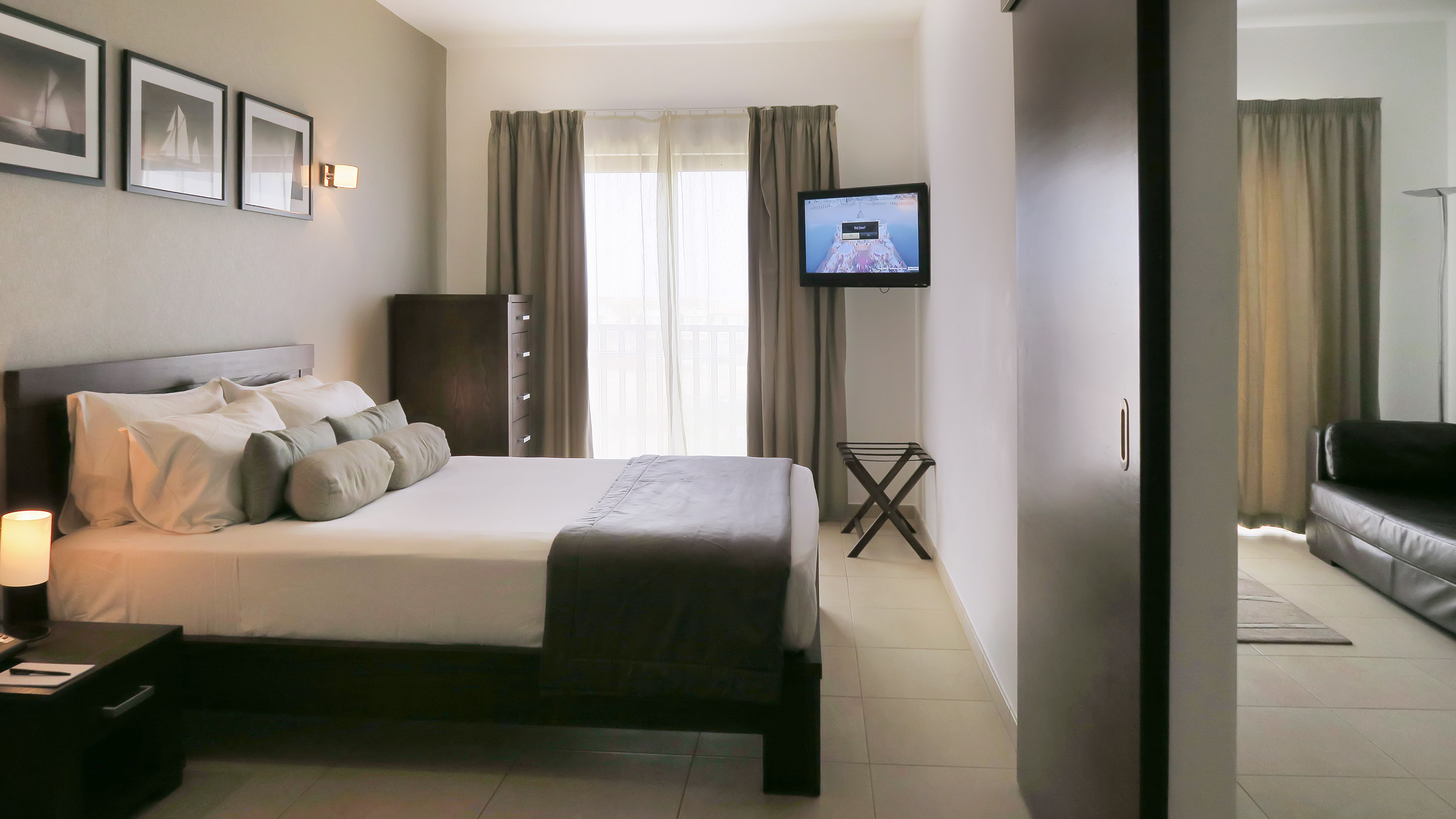 a bedroom with a television and a bed