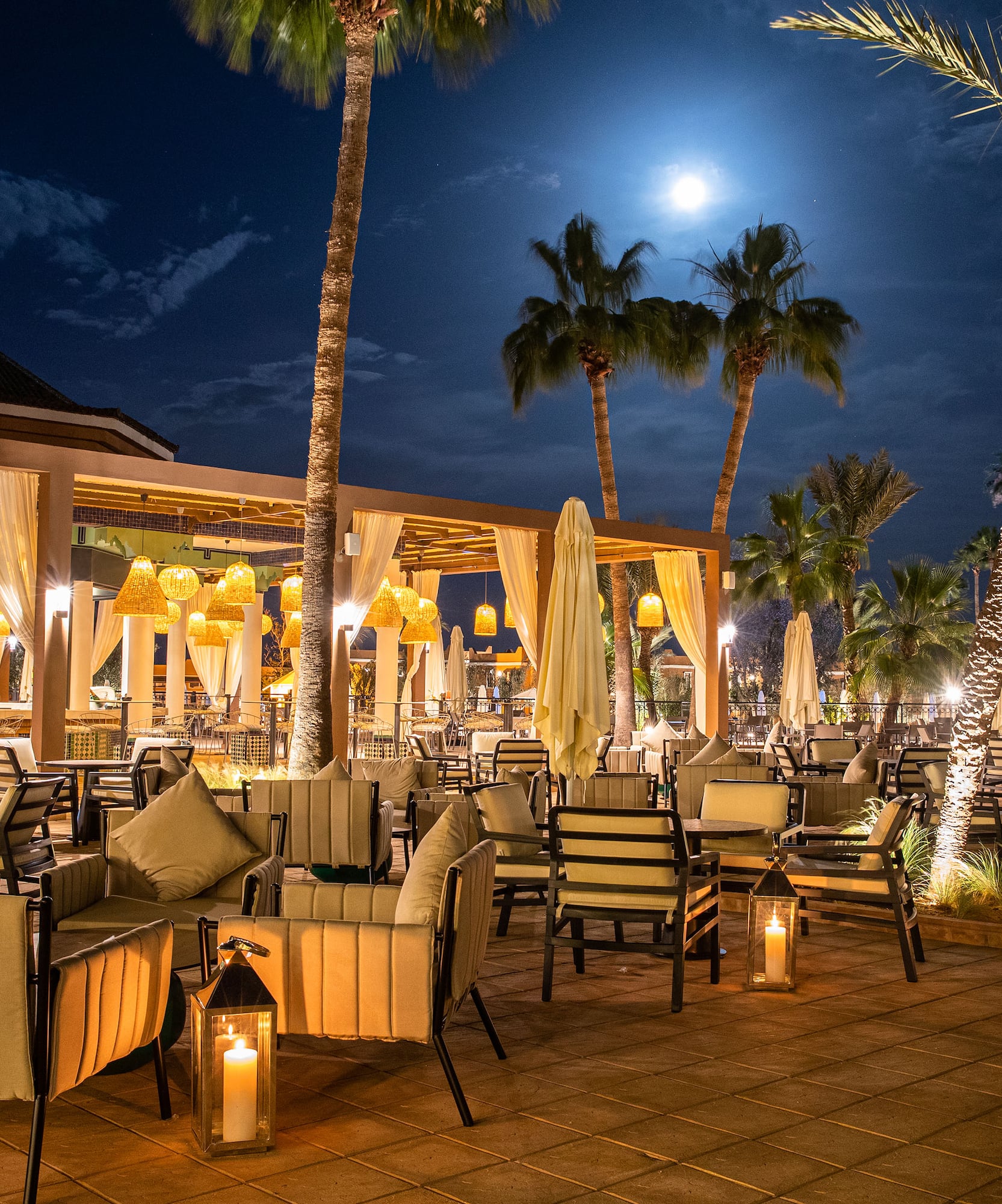 a patio with tables and chairs and umbrellas