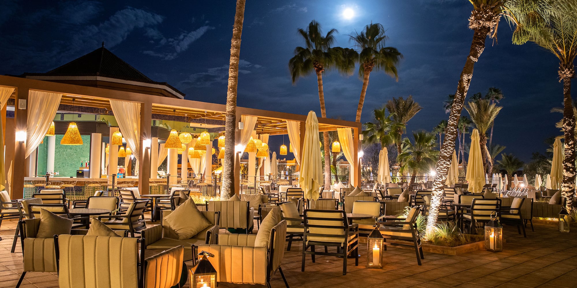 a patio with tables and chairs and umbrellas