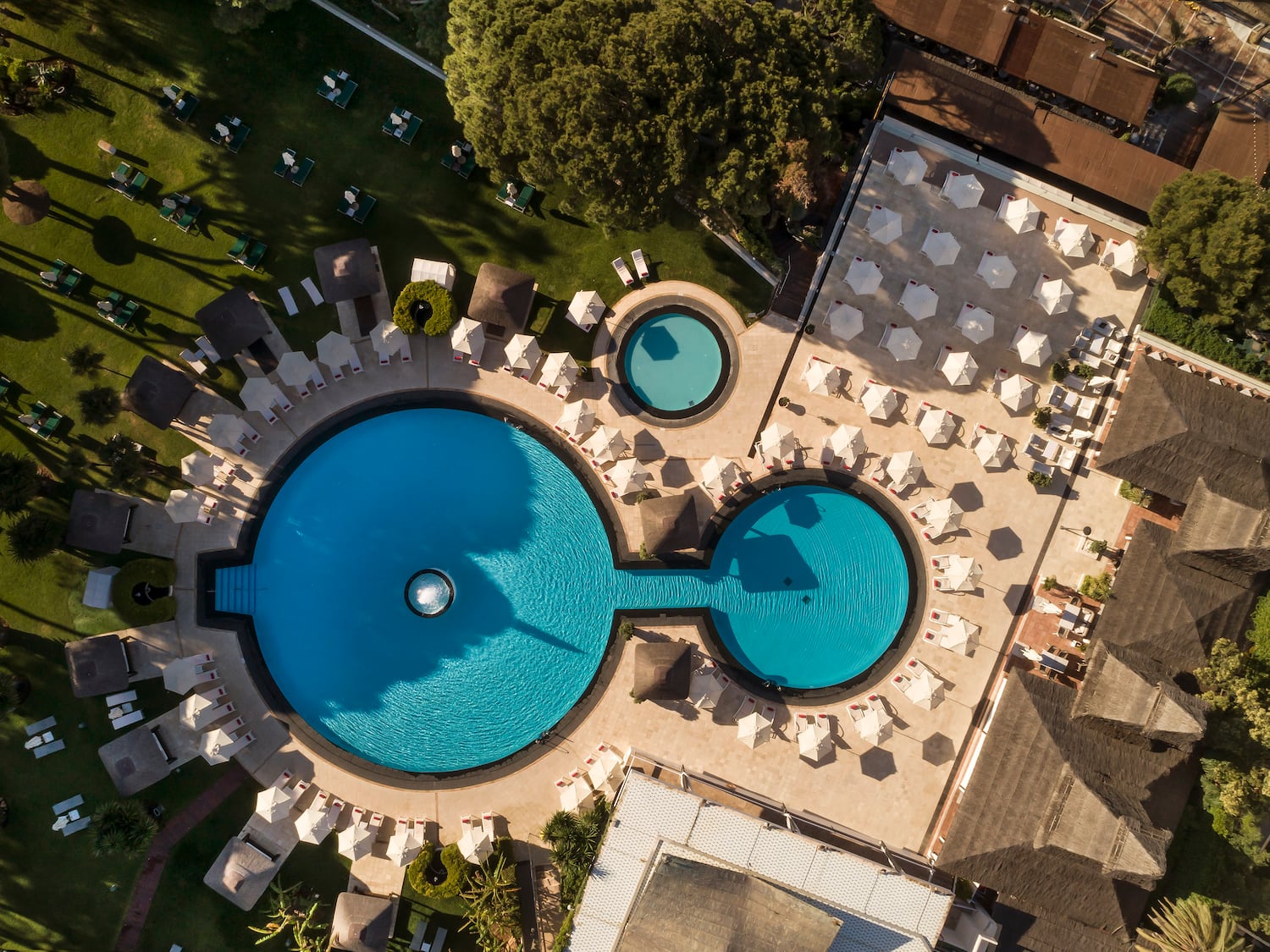 a pool with chairs and umbrellas